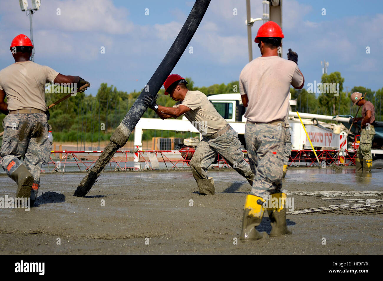 U.S. Air Force Chief Master Sgt. Bruce Thompson, Chief of the 169th Civil Engineer Squadron at McEntire Joint National Guard Base, S.C. Air National Guard, pours mixed concrete for multipurpose building foundations being constructed in support of a Deployment for Training in Israel, July 8, 2015. The construction project is to help S.C. PRIME BEEF Airmen maintain their civil engineering specialties. Swamp Fox civil engineers are working alongside 200th RED HORSE Squadron and U.S. Navy Seabees civil engineers during the training exercise. (South Carolina Air National Guard photo by Tech. Sgt. C Stock Photo