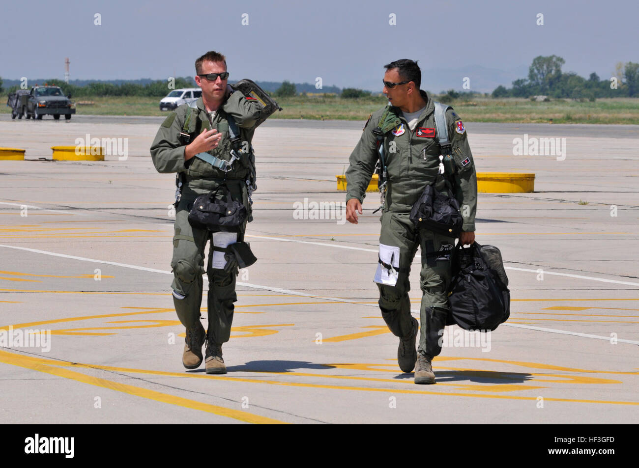 U.S. Air Force Lt. Col. Philippe Malebranche, right, and Maj. Benjamin Robbins, F-16 pilots with the 177th Fighter Wing, walk to their post-flight briefing after a training mission during Thracian Star, a bilateral training exercise to enhance interoperability with the Bulgarian air force, at Graf Ignatievo Air Base, Bulgaria, on July 13, 2015. (U.S. Air National Guard photo by Master Sgt. Andrew J. Moseley/Released) New Jersey Air National Guard trains with Bulgarian air force at Thracian Star 150713-Z-YH452-166 Stock Photo