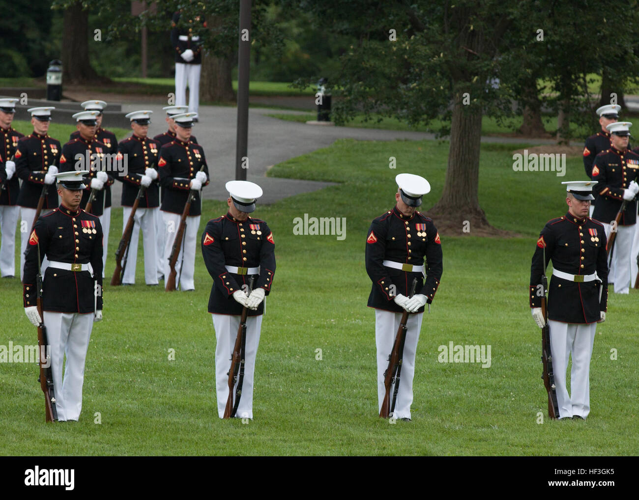 U.S. Marines with the Silent Drill Platoon perform during a sunset parade at the Marine Corps War Memorial, Arlington, Va., July 14, 2015. Dr. Jamie M. Morin, director, Cost Assessment and Program Evaluation, was the guest of honor for the parade, and Lt. Gen. Robert E. Schmidle, principal deputy director, Assessment and Program Evaluation, was the hosting official. Since September 1956, marching and musical units from Marine Barracks Washington, D.C., have been paying tribute to those whose “uncommon valor was a common virtue” by presenting sunset parades in the shadow of the 32-foot high fig Stock Photo
