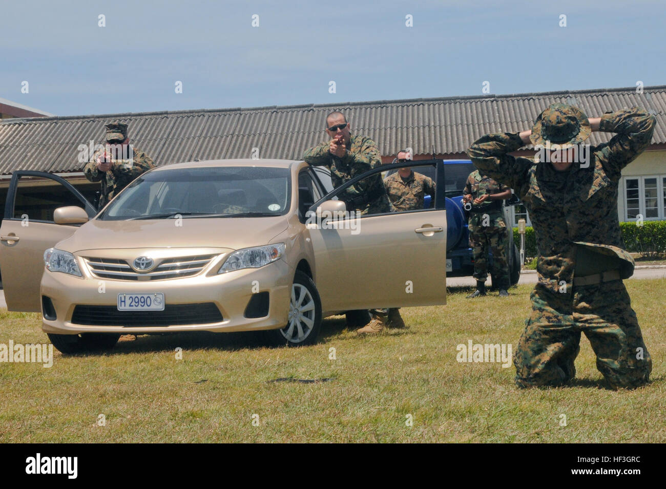 U.S. Marine Corps Lt. Col. Michael Kindorf (left) and Chief Warrant Officer 2 Victor Ojeda (center), both members of the 23rd Marine Regiment, instruct a role-player to raise his hands while demonstrating proper vehicle and individual searching techniques during a class at the Regional Barbados Police Training Center, Christ Church, Barbados, June 22, 2012. Tradewinds is a multinational, interagency exercise designed to develop and sustain relationships that improve the capacity of U.S., Canadian and 15 Caribbean partner nations' security forces to counter transnational crime and provide human Stock Photo
