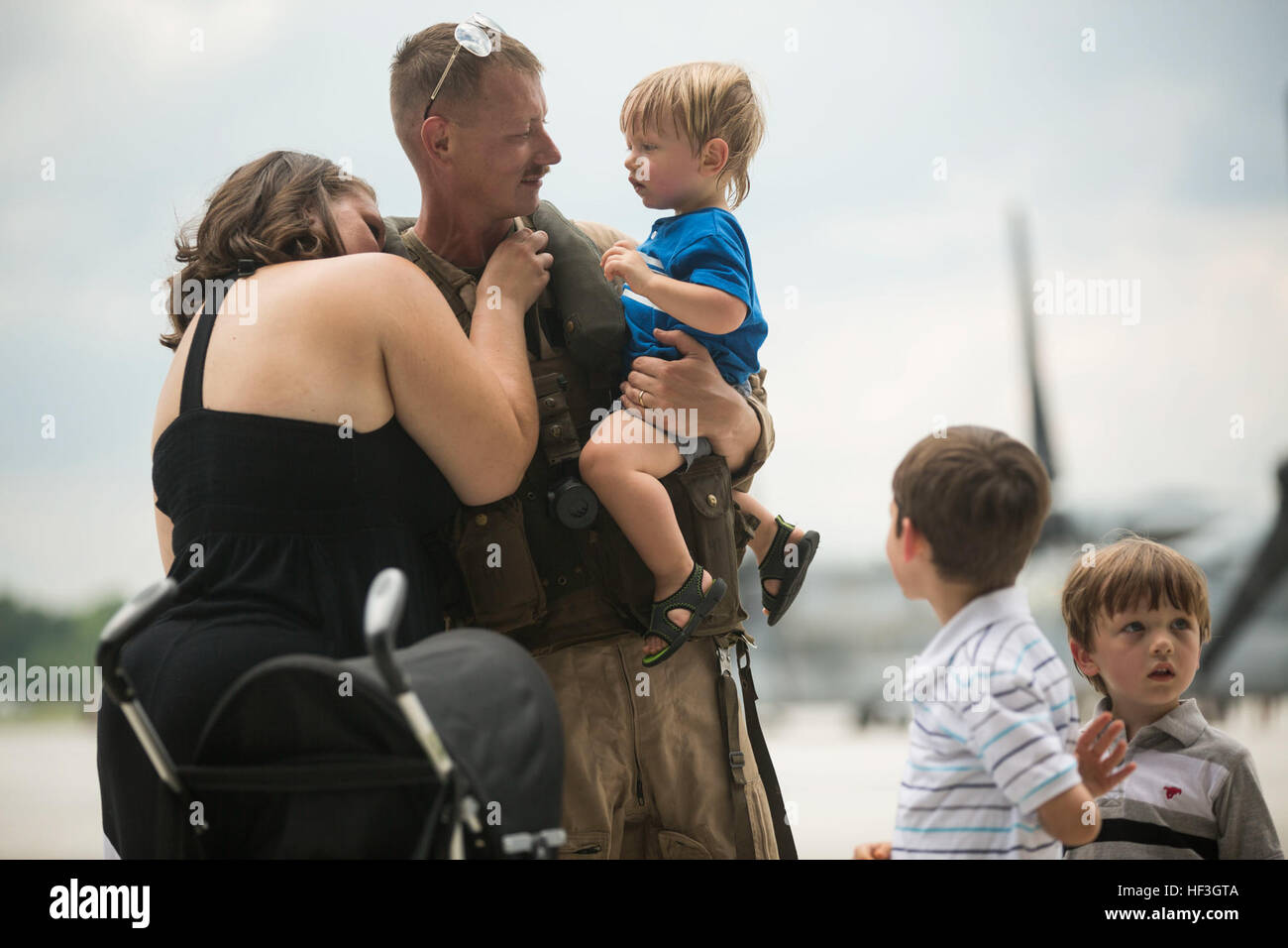 Staff Sgt. Tyler Clabaugh, a CH-53 Super Stallion helicopter mechanic with Marine Medium Tiltrotor Squadron 365 (Reinforced), 24th Marine Expeditionary Unit, reunites with his family during the Aviation Combat Element’s homecoming at Marine Corps Air Station New River, N.C. July 16, 2015. Marines and Sailors of the 24th MEU were embarked on the ships of the Iwo Jima Amphibious Ready Group and supported operations in the U.S. 5th and 6th Fleet area of operations. They also took part in numerous theater security cooperation exercises and training with allied partners such as Djibouti, Italy, Oma Stock Photo
