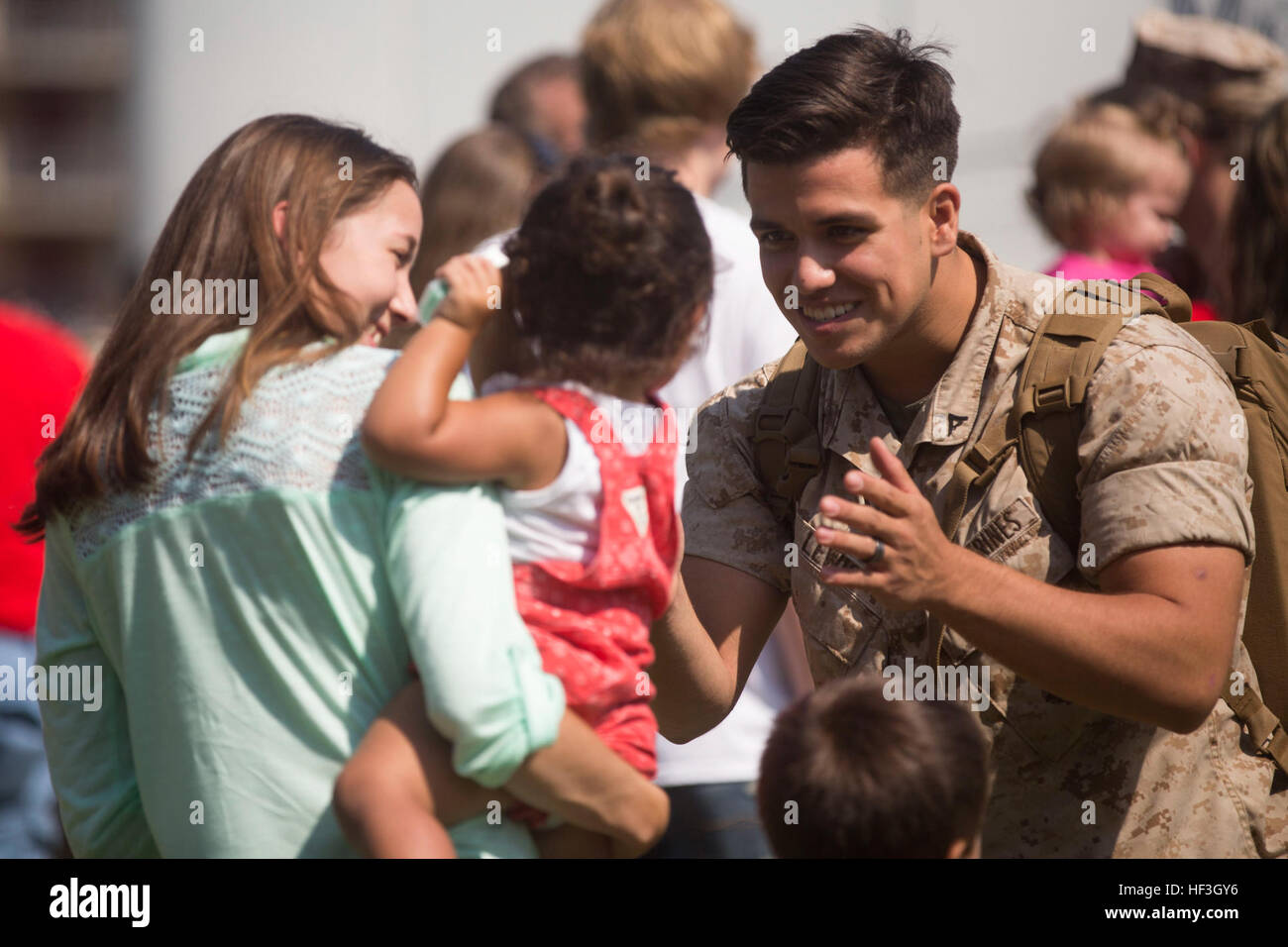 Lance Cpl. Austin Lewis, a combat photographer with the 24th Marine Expeditionary Unit, reunites with his daughter during the Command Element’s homecoming at Camp Lejeune, N.C., July 17, 2015. Marines and Sailors of the 24th MEU were embarked on the ships of the Iwo Jima Amphibious Ready Group and supported operations in the U.S. 5th and 6th Fleet area of operations. They also took part in numerous theater security cooperation exercises and training with allied partners such as Djibouti, Italy, Oman, Spain, France, Jordan, Israel, United Arab Emirates, Bahrain, Greece, Kuwait, and Saudi Arabia Stock Photo