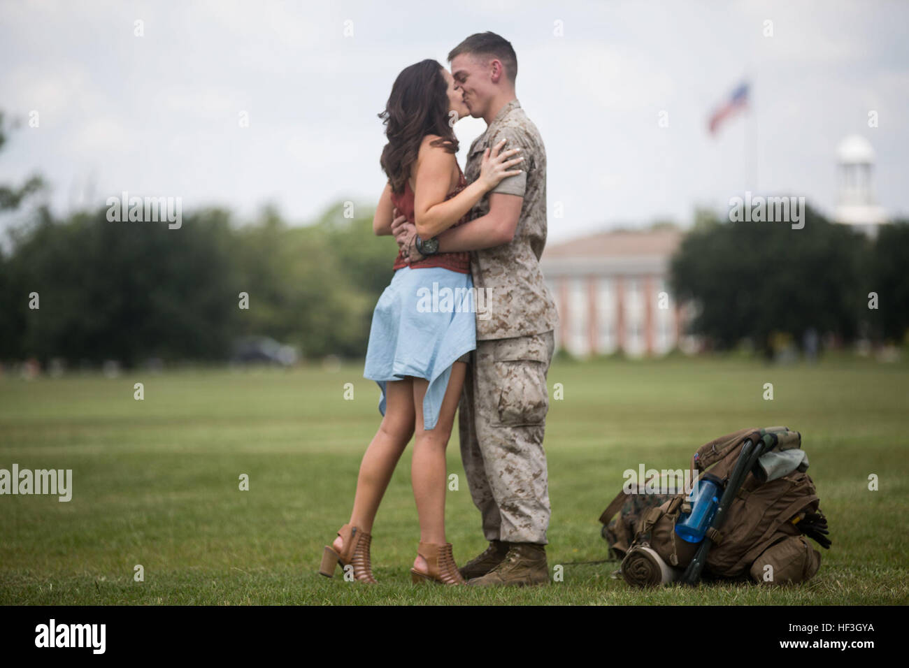 Lance Cpl. David Sellers, a refrigeration mechanic with the 24th Marine Expeditionary Unit, embraces his wife with a kiss during the Command Element’s homecoming at Camp Lejeune, N.C., July 17, 2015. Marines and Sailors of the 24th MEU were embarked on the ships of the Iwo Jima Amphibious Ready Group and supported operations in the U.S. 5th and 6th Fleet area of operations. They also took part in numerous theater security cooperation exercises and training with allied partners such as Djibouti, Italy, Oman, Spain, France, Jordan, Israel, United Arab Emirates, Bahrain, Greece, Kuwait, and Saudi Stock Photo