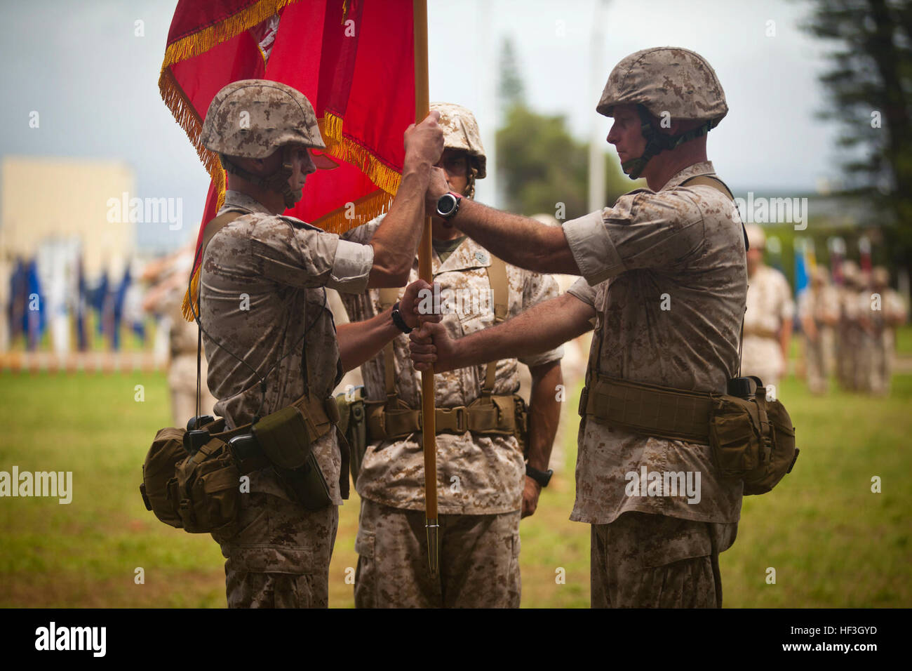 U.S. Marine Corps Col. Timothy E. Winand (right), outgoing 3rd Marine Regiment commanding officer, delivers the regimental colors to Lt. Col. Carl E. Cooper Jr. (left) during the 3rd Marine Regiment's Change of Command Ceremony at Dewey Square aboard Marine Corps Base Hawaii (MCBH), Kaneohe Bay, July 17, 2015. (U.S. Marine Corps photo by Lance Cpl. Aaron S. Patterson, MCBH Combat Camera/Released) 3D Marine Regiment Change of Command Ceremony 2015 150717-M-QH615-059 Stock Photo
