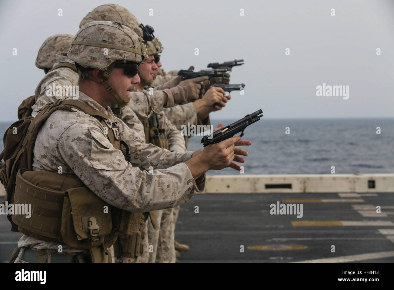 GULF OF ADEN (July 18, 2015) U.S. Marine Lance Cpl. Zachary Cox chambers a round into his M9 Beretta pistol during a weapons-switching drill aboard the amphibious transport dock ship USS Anchorage (LPD 23). Cox is a machine gunner with Battalion Landing Team 3rd Battalion, 1st Marine Regiment, 15th Marine Expeditionary Unit. BLT 3/1 is the ground combat element of the 15th MEU and, embarked aboard the ships of the Essex Amphibious Ready Group, is deployed in support of maritime security operations and theater security cooperation efforts in the U.S. 5th Fleet area of operations. (U.S. Marine C Stock Photo