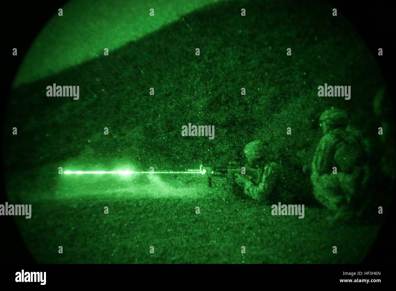 ARTA BEACH, Djibouti (July 22, 2015) A U.S. Marine with Battalion Landing Team 3rd Battalion, 1st Marine Regiment, 15th Marine Expeditionary Unit, fires an M4 Carbine during a night-fire exercise.  The Marines of BLT 3/1 executed a series of attack and maneuver drills consisting of, machine gun, squad and night attacks.  Elements of the 15th Marine Expeditionary Unit are ashore in Djibouti for sustainment training to maintain and enhance the skills they developed during their pre-deployment training period.  The 15th MEU is currently deployed in support of maritime security operations and thea Stock Photo