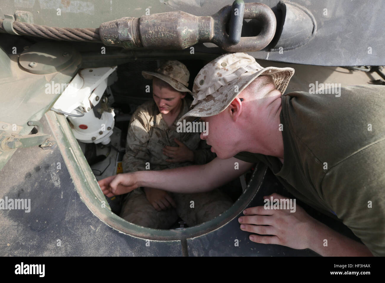 ARTA BEACH, Djibouti (July 24, 2015)  U.S. Marine Lance Cpl. Paul Shabel, right, shows Lance Cpl. Jacob Bowen, left, the driver controls of an M1A1 Abrams tank. Shabel is a tank driver with Battalion Landing Team 3rd Battalion, 1st Marine Regiment, 15th Marine Expeditionary Unit, and Bowen is a rifleman with BLT 3/1, 15th MEU. Elements of the 15th Marine Expeditionary Unit are ashore in Djibouti for sustainment training to maintain and enhance the skills they developed during their pre-deployment training period.  The 15th MEU is currently deployed in support of maritime security operations an Stock Photo