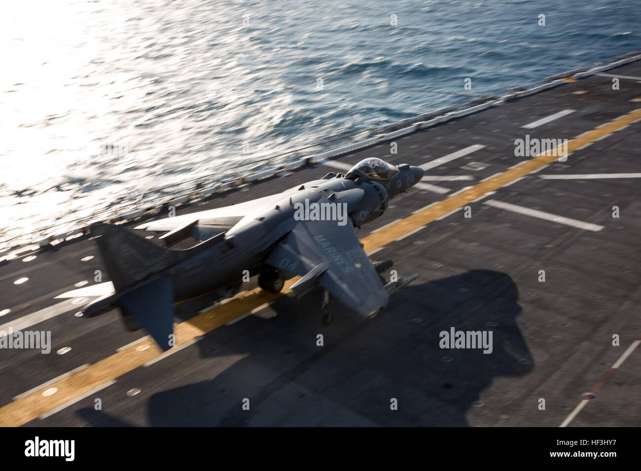 An AV-8B Harrier pilot with Marine Attack Squadron (VMA) 214 conducts a short takeoff from the flight deck of the USS Boxer, Aug. 5. For several hours, the pilot practiced taking off and landing while aboard a moving Navy ship. (U.S. Marine Corps photo by Sgt. Lillian Stephens/Released) Harrier with VMA-214 'Black Sheepf conducts flight quarters 150805-M-QU349-102 Stock Photo