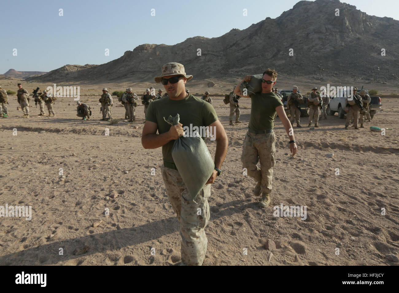Southwest Asia (Aug. 18, 2015)  U.S. Marine Cpl. William Bowling, left, and Lance Cpl. James White carry sand bags during a range setup. Bowling is a radio operator and White is a rifleman with India Company, Battalion Landing Team 3rd Battalion, 1st Marine Regiment, 15th Marine Expeditionary Unit. The 15th MEU is deployed throughout Southwest Asia to maintain regional security in the U.S. 5th Fleet area of operations.  The 15th MEU provides flexible, responsive options across the range of military operations to support regional security in the U.S. 5th Fleet AOR. (U.S. Marine Corps photo by S Stock Photo