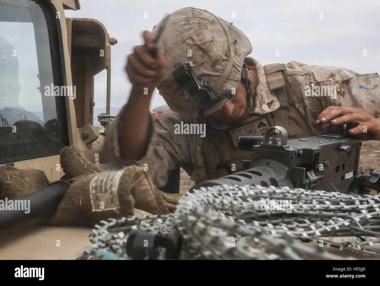 Lance Cpl. Jay Singh, a U.S. Marine with the Combined Anti-Armor Team (CAAT) within Battalion Landing Team (BLT) 2/1, the ground combat element for the 13th Marine Expeditionary Unit, performs maintenance on an M2 .50-Caliber machine gun during training on Aug. 21, 2015. The CAAT, composed of heavy machine gunners and anti-tank missilemen, is used to combat hardened targets as well as provide security. (U.S. Marine Corps photo by Sgt. Paris Capers /RELEASED) 13th MEU CAATs pack one-two punch 150822-M-NI439-093 Stock Photo
