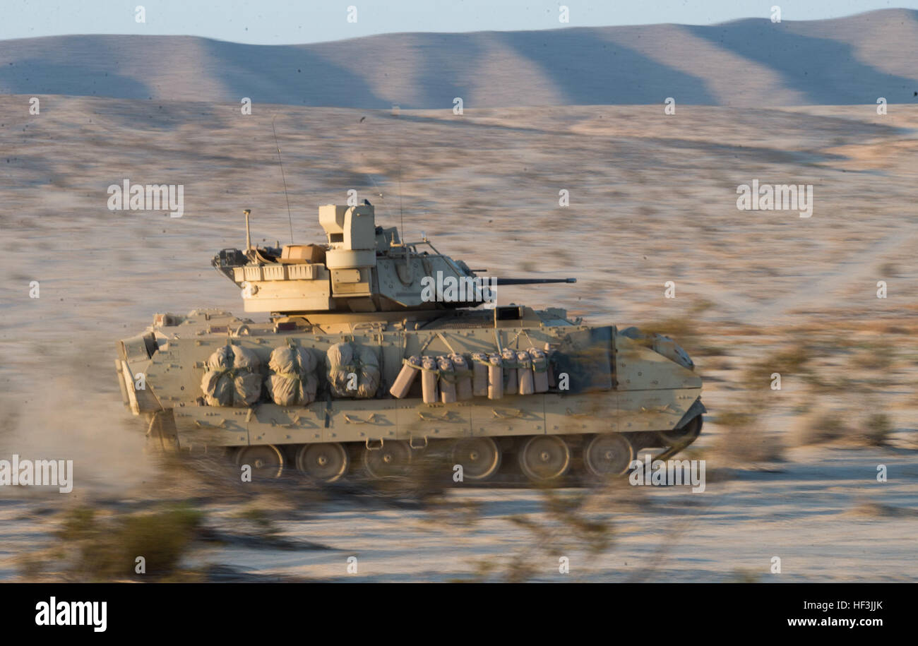 Soldiers from A Company, 3rd Battalion, 116th Cavalry Brigade Combat Team (CBCT), race their M2A3 Bradley Infantry Fighting Vehicle toward the opposition force (OPFOR) during a battle simulation exercise at the National Training Center (NTC), Fort Irwin, Calif., Aug. 22. More than 5,000 Soldiers with National Guard units from 10 states, the U.S. Army Reserve and active duty U.S. Army Soldiers are participating in the exercise as part of their annual training. (Photo by Maj. W. Chris Clyne, 115th Mobile Public Affairs Detachment) NTC Rotation 15-09 starts off with a bang 150822-Z-ZJ128-001 Stock Photo