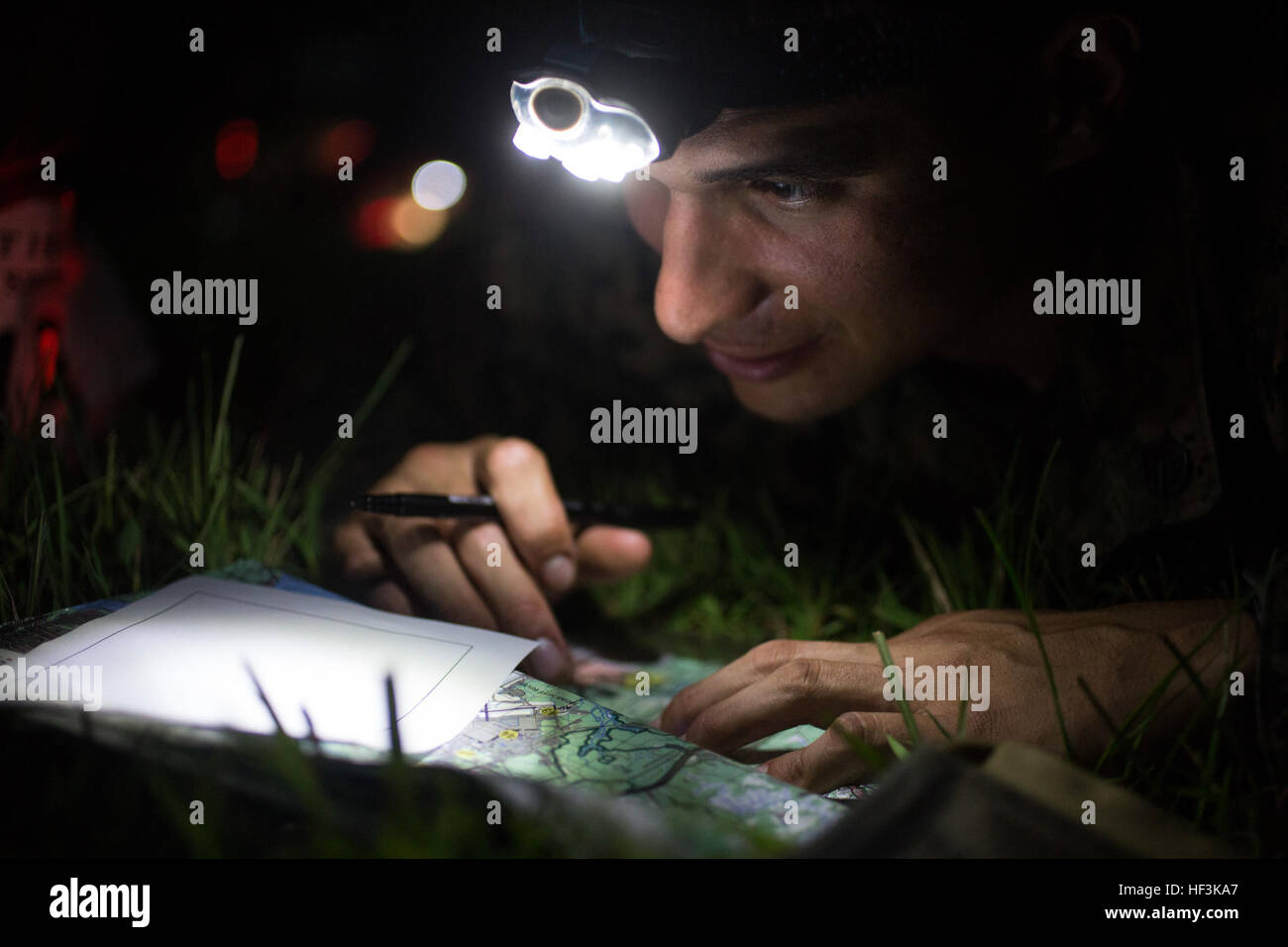 U.S. Marine Staff Sgt. Aldo Gongora a Combat Instructor with InfantryTraining Battalion, School of Infantry-East plots points on his map before a five hour night navigation course; an event in the Combat Instructor Stakes on Sept. 10, 2015.  The Combat Instructor Stakes is a grueling 32-hour competition that pits two man, Combat Instructor teams against each other competing in physical, tactical and knowledge based events while carrying a combat load and moving over 55 Kilometers on foot.  (U.S. Marine Corps Photo by SOI-E Combat Camera, Cpl. Andrew Kuppers/Released) Combat Instructor Stakes 1 Stock Photo