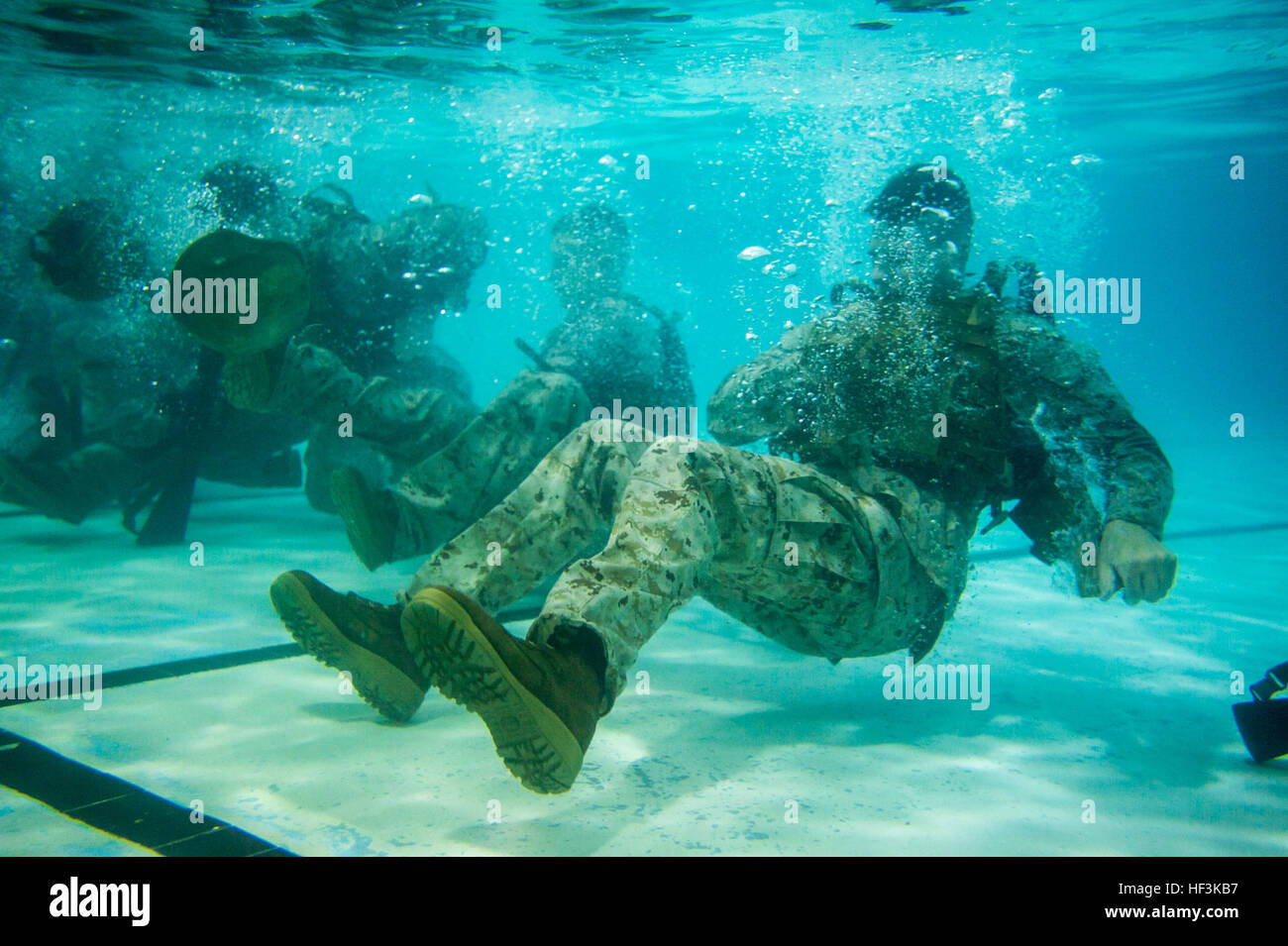 U.S. Marines with The Basic School shed their gear during their basic and intermediate swim qualification course at The Basic School, Marine Corps Base Quantico, Va., Sept. 10, 2015. The course teaches Marines water survival and tactical skills. (U.S. Marine Corps photo by Lance Cpl. Jacqueline A. Garcia/Released) The Basic School Golf Co Swim Qual 150910-M-PO745-205 Stock Photo
