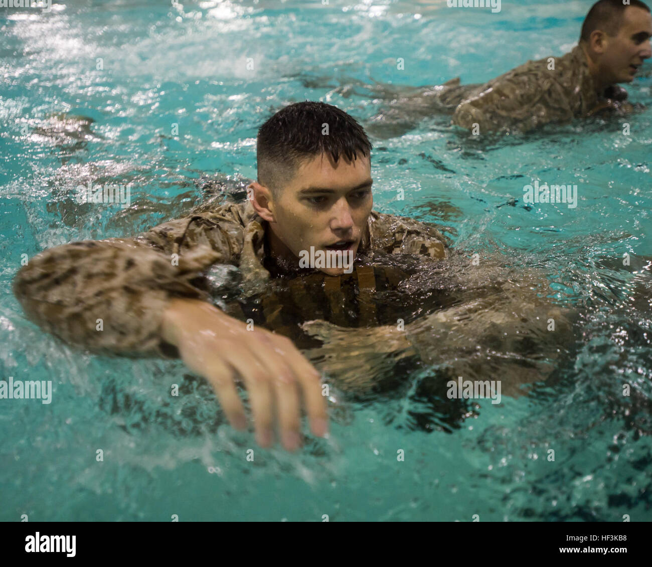 A U.S. Marine with The Basic School swims with a pack across the pool during the basic and intermediate swim qualification course at The Basic School, Marine Corps Base Quantico, Va., Sept. 10, 2015. The course teaches Marines water survival and tactical skills. (U.S. Marine Corps photo by Lance Cpl. Jacqueline A. Garcia/Released) The Basic School Golf Co Swim Qual 150910-M-PO745-216 Stock Photo