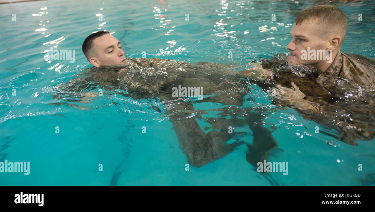 U.S. Marines with The Basic School help each other stay afloat during the basic and intermediate swim qualification course at The Basic School, Marine Corps Base Quantico, Va., Sept. 10, 2015. The course teaches Marines water survival and tactical skills. (U.S. Marine Corps photo by Lance Cpl. Jacqueline A. Garcia/Released) The Basic School Golf Co Swim Qual 150910-M-PO745-444 Stock Photo