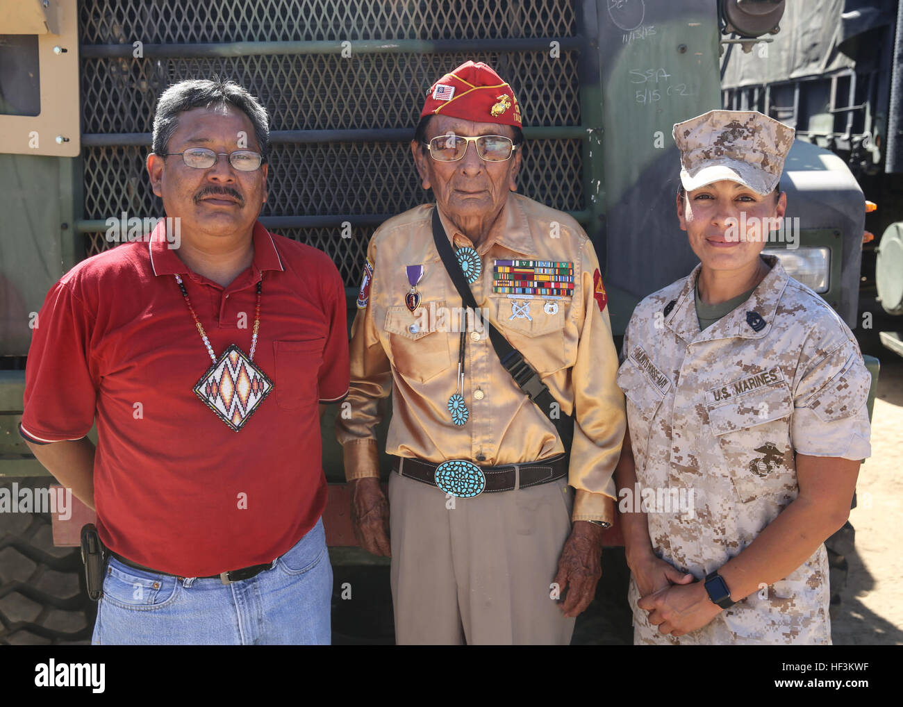 Navajo Code Talker Samuel T. Holiday poses with his son, Ricky Gray, and 1st Sgt. Christina Hunts Horse-May, first sergeant for Company C, 9th Communication Battalion, I Marine Expeditionary Force Headquarters Group, during a visit to a static display held by 9th Comm. Bn. aboard Marine Corps Base Camp Pendleton, Calif., Sept. 28, 2015. The visit allowed for the Marines to showcase their communications capabilities and build a bond between them and the Code Talkers. (U.S. Marine Corps photo by Pfc. Devan K. Gowans) Navajo Code Talkers tune in with 9th Comm Bn. 150928-M-GM943-121 Stock Photo
