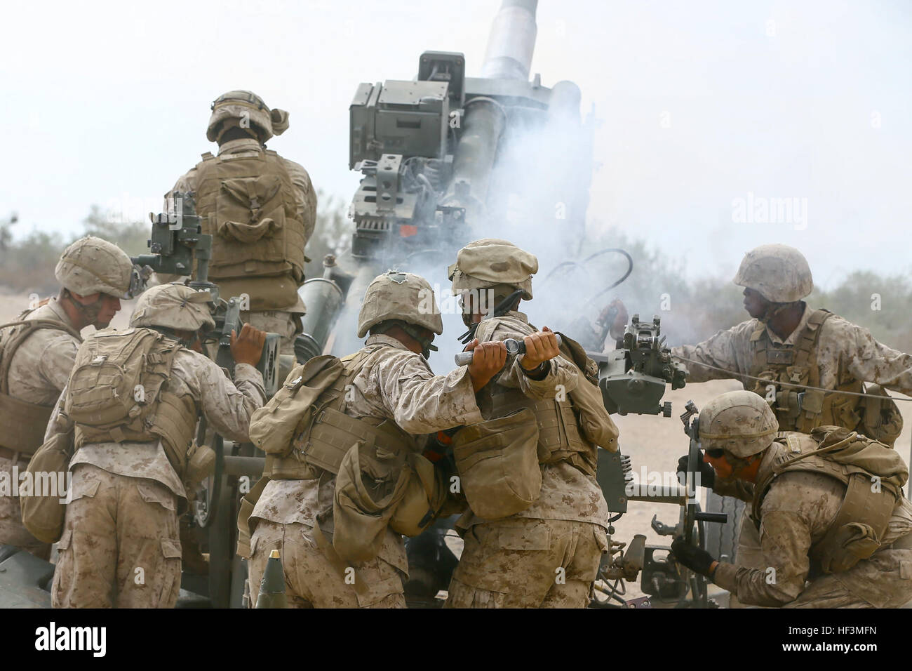 U.S. Marines with C Battery, 1st Battalion, 11th Marine Regiment, 1st Marine Division fire a M777 howitzer during an assault support tactics exercise at Fire Base Burt, Chocolate Mountain Aerial Gunnery Range, Calif., Oct. 12, 2015. The exercise is part of Weapons and Tactics Instructor (WTI) 1-16, a seven-week training event hosted by Marine Aviation Weapons and Tactics Squadron One (MAWTS-1) cadre. MAWTS-1 provides standardized tactical training and certification of unit instructor qualifications to support Marine Aviation Training and Readiness and assists in developing and employing aviati Stock Photo