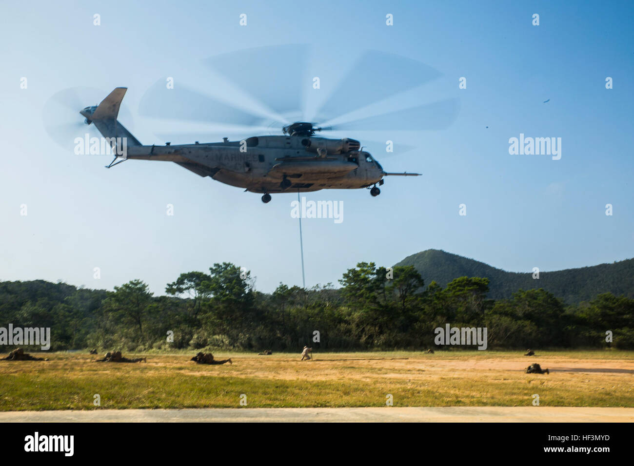 Military police Marines conduct fast roping out of a CH-53E Super Stallion in support of Blue Chromite 16 in the Central Training Area, Okinawa, Japan, Oct. 28, 2015. The Marines, with the help of a military working dog, were tasked with tracking down the pilot and two downed aircrew members on a simulated downed aircraft. Blue Chromite is a large-scale amphibious exercise that draws primarily from III Marine Expeditionary Force’s training resources on Okinawa. The location of the training allows participating units to maintain a forward-deployed posture and eliminates the cost of traveling to Stock Photo