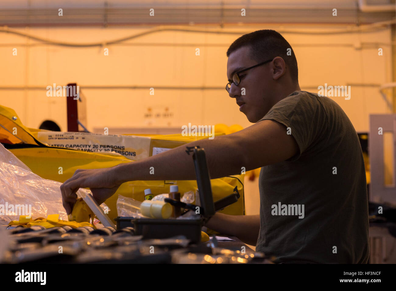 U.S. Marine Corps Lance Cpl. Roberto F. Cantu, a flight equipment technician assigned to Marine Aviation Logistics Squadron (MALS) 14, replaces expired supplies from the lift raft of a KC-130J Hercules  on Marine Corps Air Station Cherry Point, N.C., Nov. 19, 2015. The Aviation Life Support System section of MALS-14 supports aviation units by ensuring pilots and air crew are equipped with life support equipment and supplies. (U.S. Marine Corps photo by Lance Cpl. Jered T. Stone/Released) MALS-14 ALSS Daily Operations 151119-M-WP334-002 Stock Photo