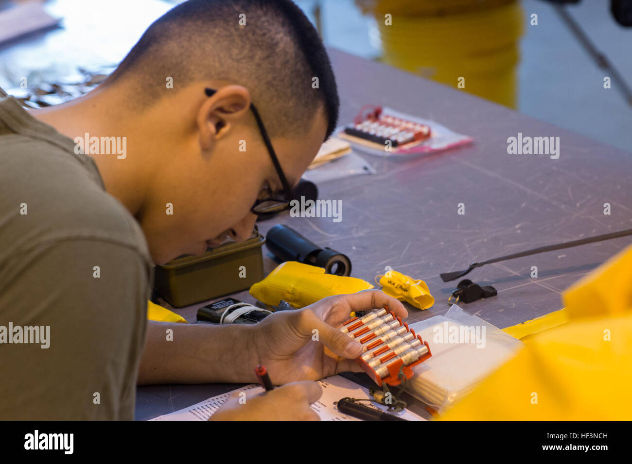 U.S. Marine Corps Lance Cpl. Roberto F. Cantu, a flight equipment technician assigned to Marine Aviation Logistics Squadron (MALS) 14, inspects pen flares from the life raft of a KC-130J Hercules on Marine Corps Air Station Cherry Point, N.C., Nov. 19, 2015. The Aviation Life Support System section of MALS-14 supports aviation units by ensuring pilots and air crew are equipped with life support equipment and supplies. (U.S. Marine Corps photo by Lance Cpl. Jered T. Stone/Released) MALS-14 ALSS Daily Operations 151119-M-WP334-010 Stock Photo