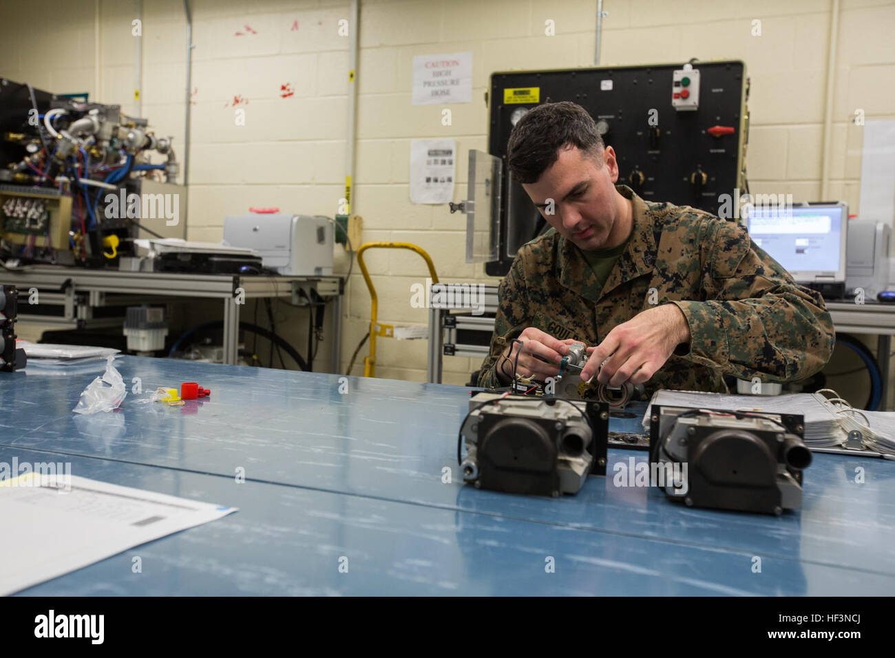 U.S. Marine Corps Cpl. Thomas C. Gould, a flight equipment technician assigned to Marine Aviation Logistics Squadron (MALS) 14, repairs an oxygen regulator from a KC-130J Hercules on Marine Corps Air Station Cherry Point, N.C., Nov. 19, 2015. The Aviation Life Support System section of MALS-14 supports aviation units by ensuring pilots and air crew are equipped with life support equipment and supplies. (U.S. Marine Corps photo by Lance Cpl. Jered T. Stone/Released) MALS-14 ALSS Daily Operations 151119-M-WP334-018 Stock Photo