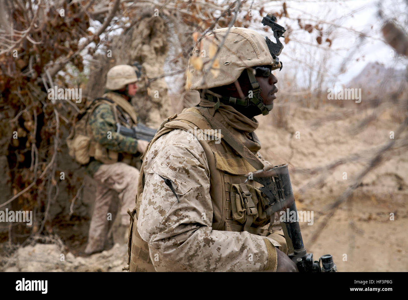 091209-M-2293M-019 NOW ZAD VALLEY, Afghanistan (Dec. 9, 2009) Hospital Corpsman 2nd Class Rashad Collians, assigned to Lima Company, 3rd Battalion, 4th Marine Regiment, watches his field of fire in the Now Zad Valley, Afghanistan. Marines and Sailors are clearing the area of Taliban presence so the local population may return to their homes. (U.S. Marine Corps photo by Cpl. Daniel M. Moman/Released) US Navy 091209-M-2293M-019 Hospital Corpsman 2nd Class Rashad Collians, assigned to Lima Company, 3rd Battalion, 4th Marine Regiment, Stock Photo