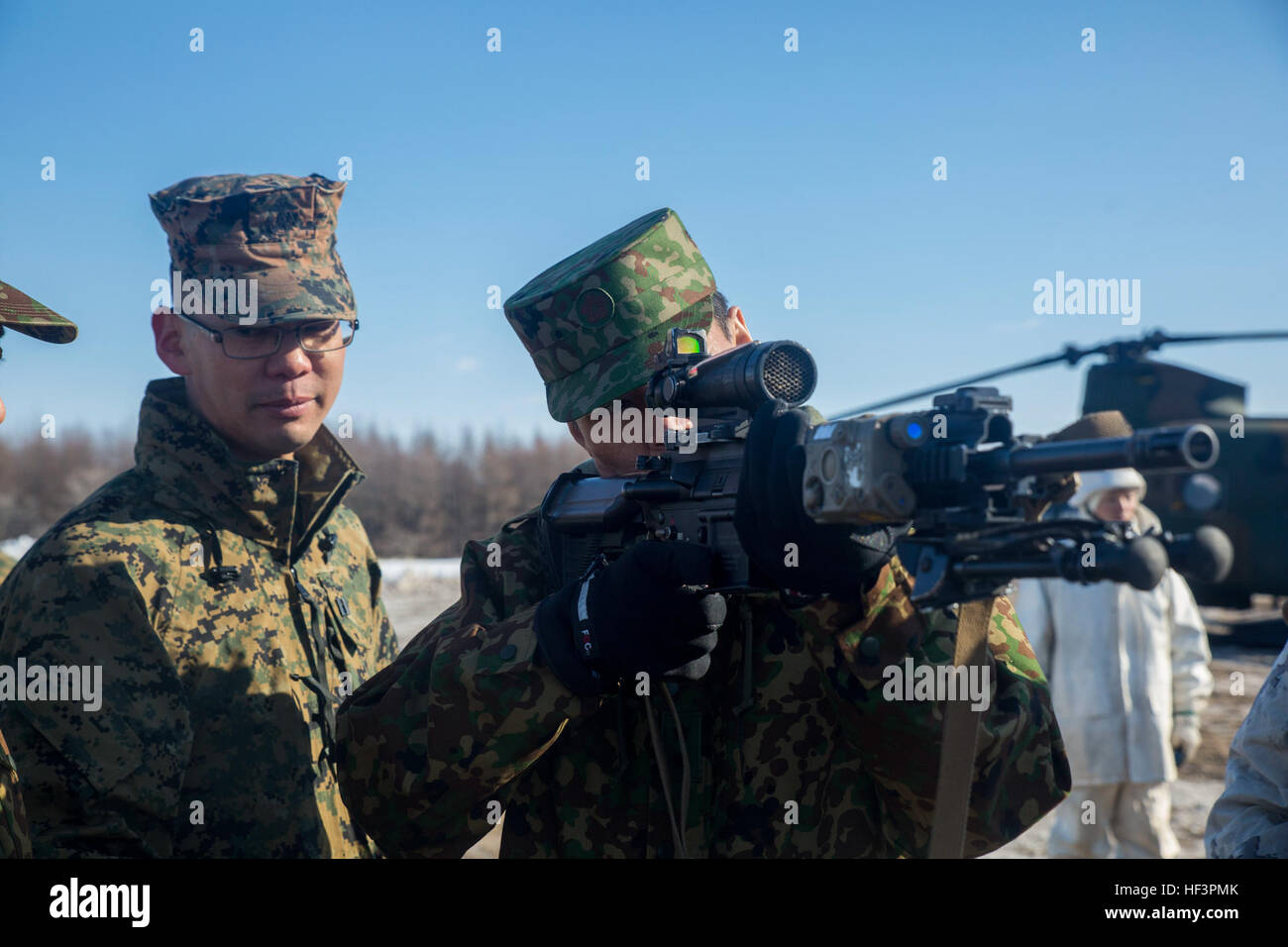 Japan Ground Self Defense Force Lt. Gen. Yukio Masakia handles an M27 Infantry Automatic Rifle during Forest Light 16-2 in Yausubetsu Training Area, Hokkaido, Japan, Feb. 1, 2016. The general toured the area with U.S. Marine Maj. Gen. Richard L Simcock, the commanding general of 3rd Marine Division and deputy commander for Marine Corps Forces, Pacific. The exercise strengthens military partnership, solidifies regional security agreements and improves individual and unit-level skills. Masakia is the 5th Brigade commanding general for the Northern Army. The Marines are with Kilo Company, 3rd Bat Stock Photo