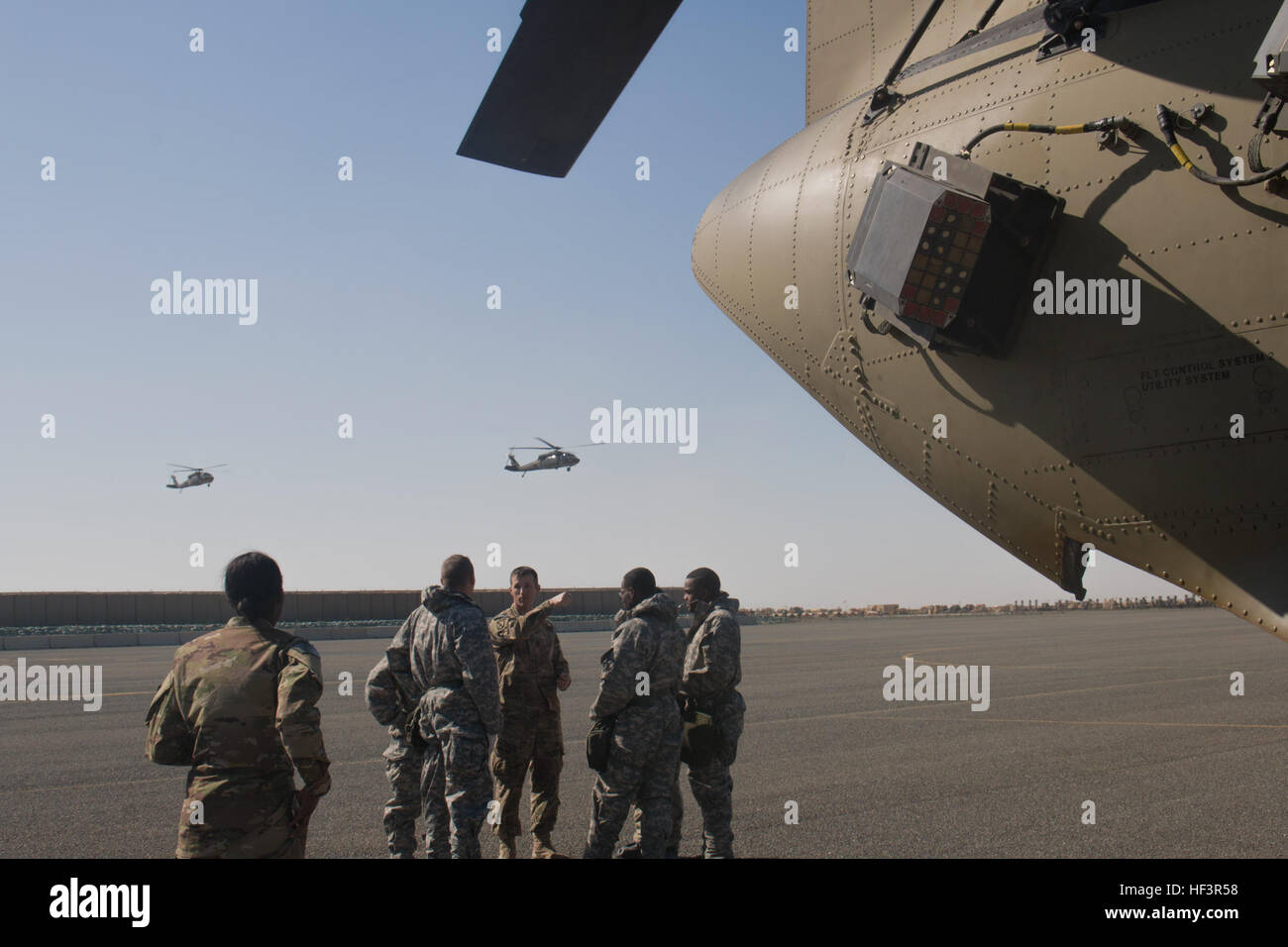 Army Reserve Sgt. 1st Class Robert Wilson, an Augusta, Ga., resident and platoon sergeant in the 366th Chemical Co., briefs his Soldiers during a decontamination exercise of a CH-47 Chinook helicopter belonging to Company B, 1st Battalion, 168th Aviation Regiment, 40th Combat Aviation Brigade, at Camp Arifjan, Kuwait, Feb. 9. Chemical, Biological, Radiological and Nuclear procedures are covered by Camp Arifjan’s pre-accident plan, which covers a wide range of emergencies that could occur during operations. (Photo by Staff Sgt. Ian M. Kummer, 40th Combat Aviation Brigade Public Affairs) 40th CA Stock Photo