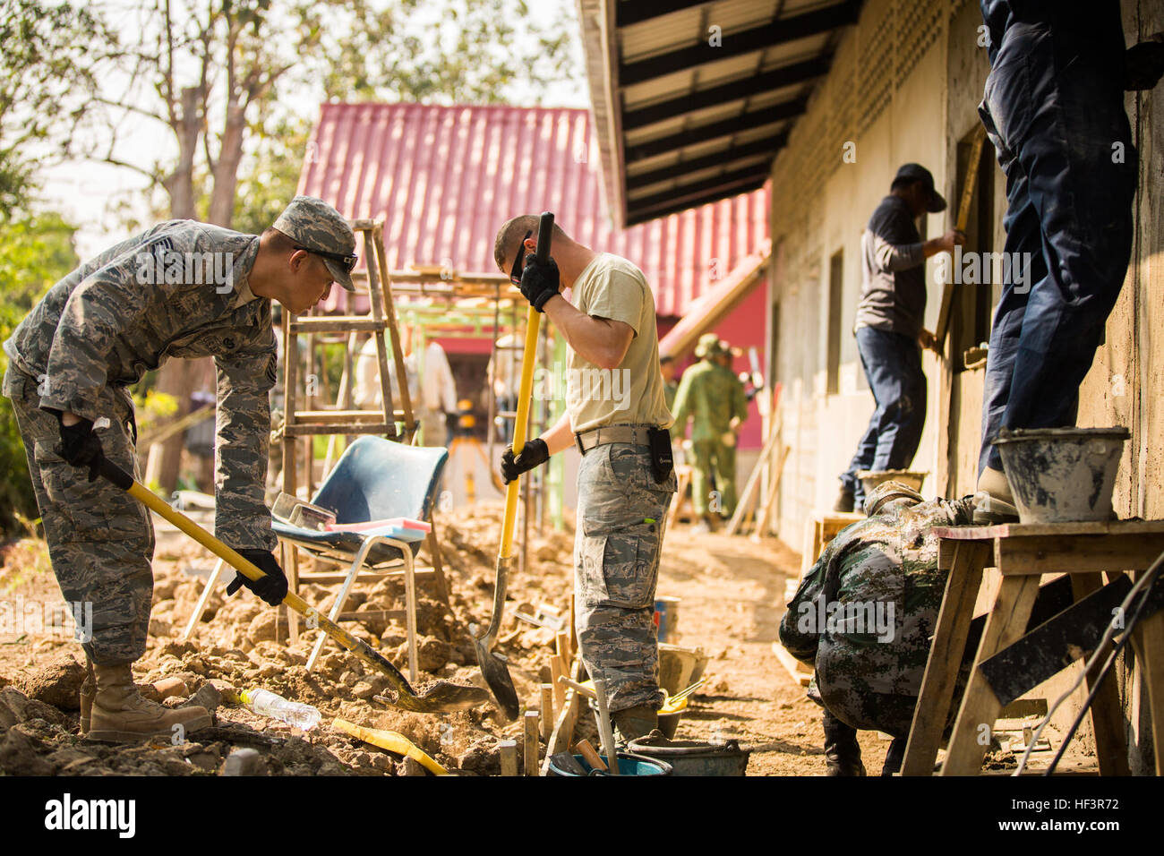 Service members from the U.S. and Royal Thai Air Forces, Singapore and People's Republic of China, People's Liberation Army build a classroom at the Wat Ban Mak school, Saraburi, Thailand, during exercise Cobra Gold, Feb. 9, 2016. Cobra Gold, in its 35th iteration, focuses on humanitarian civic action, community engagement, and medical activities to support the needs and humanitarian interest of civilian populations around the region. (U.S. Marine Corps Combat Camera photo by Cpl. Wesley Timm/Released) Construction Continues at the Wat Ban Mak School During Exercise Cobra Gold 160209-M-AR450-0 Stock Photo