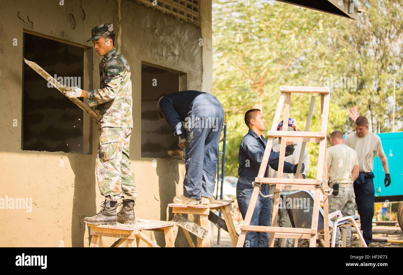 Service members from the U.S. and Royal Thai Air Forces, Singapore and People's Republic of China, People's Liberation Army build a classroom at the Wat Ban Mak school, Saraburi, Thailand, during exercise Cobra Gold, Feb. 9, 2016. Cobra Gold, in its 35th iteration, focuses on humanitarian civic action, community engagement, and medical activities to support the needs and humanitarian interest of civilian populations around the region. (U.S. Marine Corps Combat Camera photo by Cpl. Wesley Timm/Released) Construction Continues at the Wat Ban Mak School During Exercise Cobra Gold 160209-M-AR450-0 Stock Photo