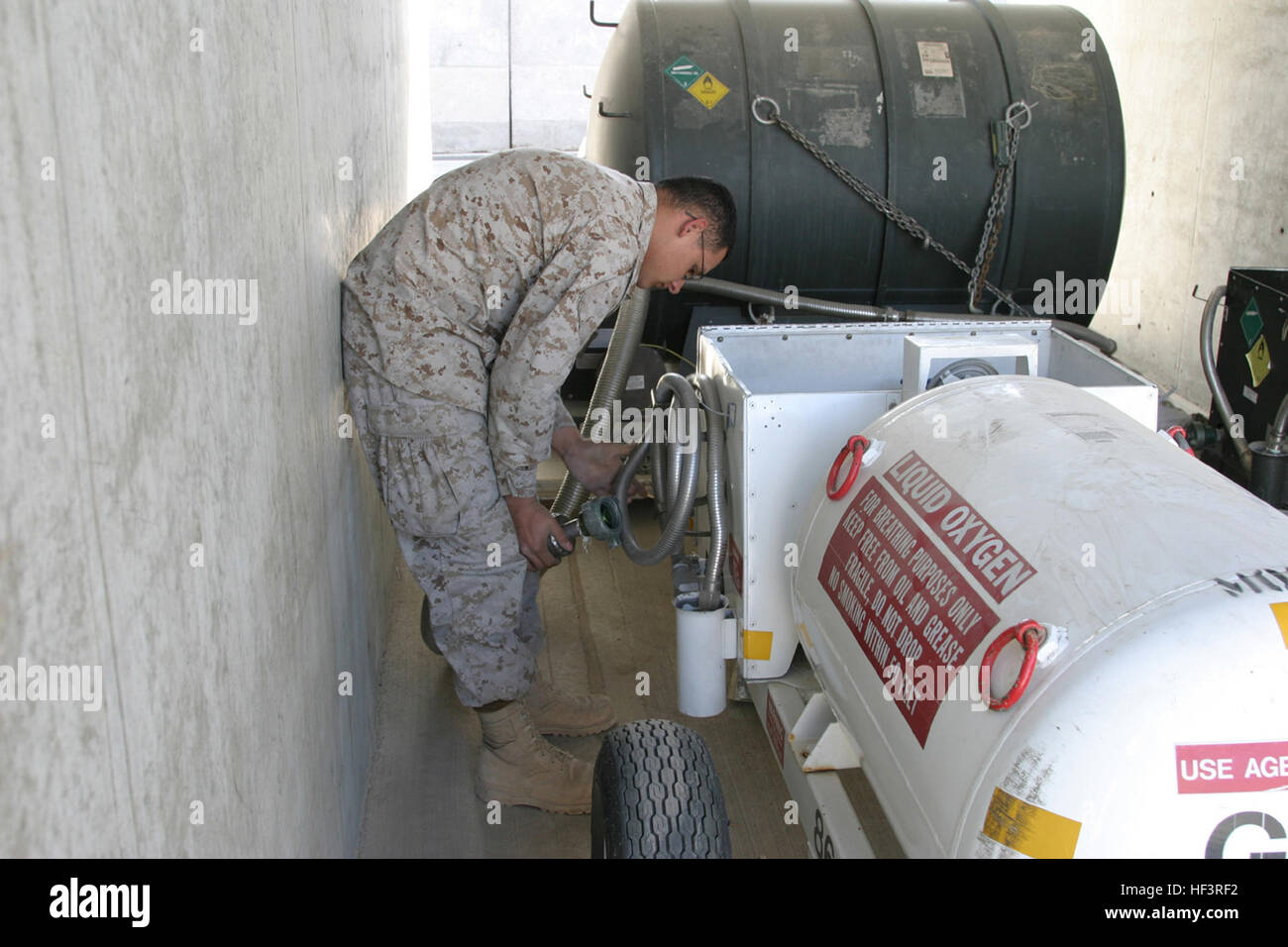 Lance Cpl. Erick Zuniga, a mechanic with Marine Aviation Logistics Squadron 40, Marine Aircraft Group 40, Marine Expeditionary Brigade-Afghanistan, fills up a 50 gallon TMU-27 oxygen tank for a KC-130J Hercules aircraft in preparation for a battlefield illumination mission, Dec. 17, 2009. MALS-40 assists MAG-40 with supplies, logistics DVIDS237370 Stock Photo