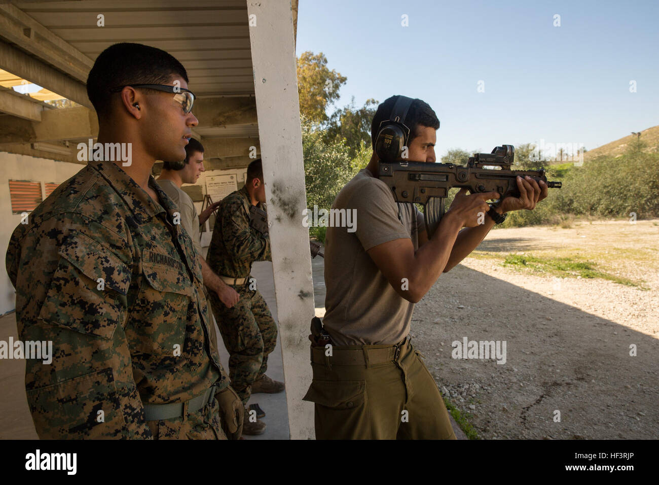 An Israel Defense Force soldier instructs a U.S. Marine on the use of ...
