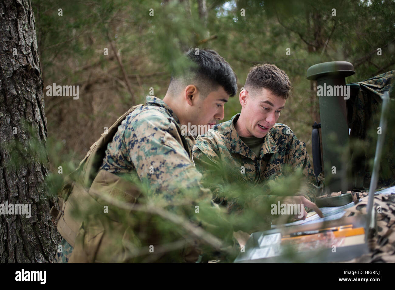 U.S. Marine Corps Lance Cpl. Enrique Delavega, left, and Cpl. Dakota H. Messier, both low altitude air defense gunners assigned to 2d Low Altitude Air Defense Battalion (2D LAAD), Marine Medium Tiltrotor Squadron 264 (reinforced), consult a map during ground based air defense training on Marine Corps Outlying Field Atlantic, N.C., Feb. 15, 2016. 2D LAAD conducted the training in preparation for deployment with the 22nd Marine Expeditionary Unit. (U.S. Marine Corps photo by Cpl. Jodson B. Graves/Released) 2D LAAD Pre-Deployment Training 160217-M-SW506-078 Stock Photo