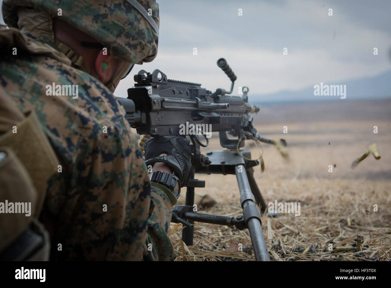A U.S. Marine with 1st Battalion, 3rd Marine Regiment, fires an M240 ...