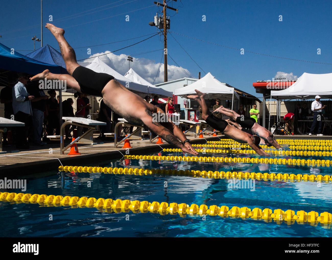 U.S. Marines and veterans with the Wounded Warrior Regiment dive into