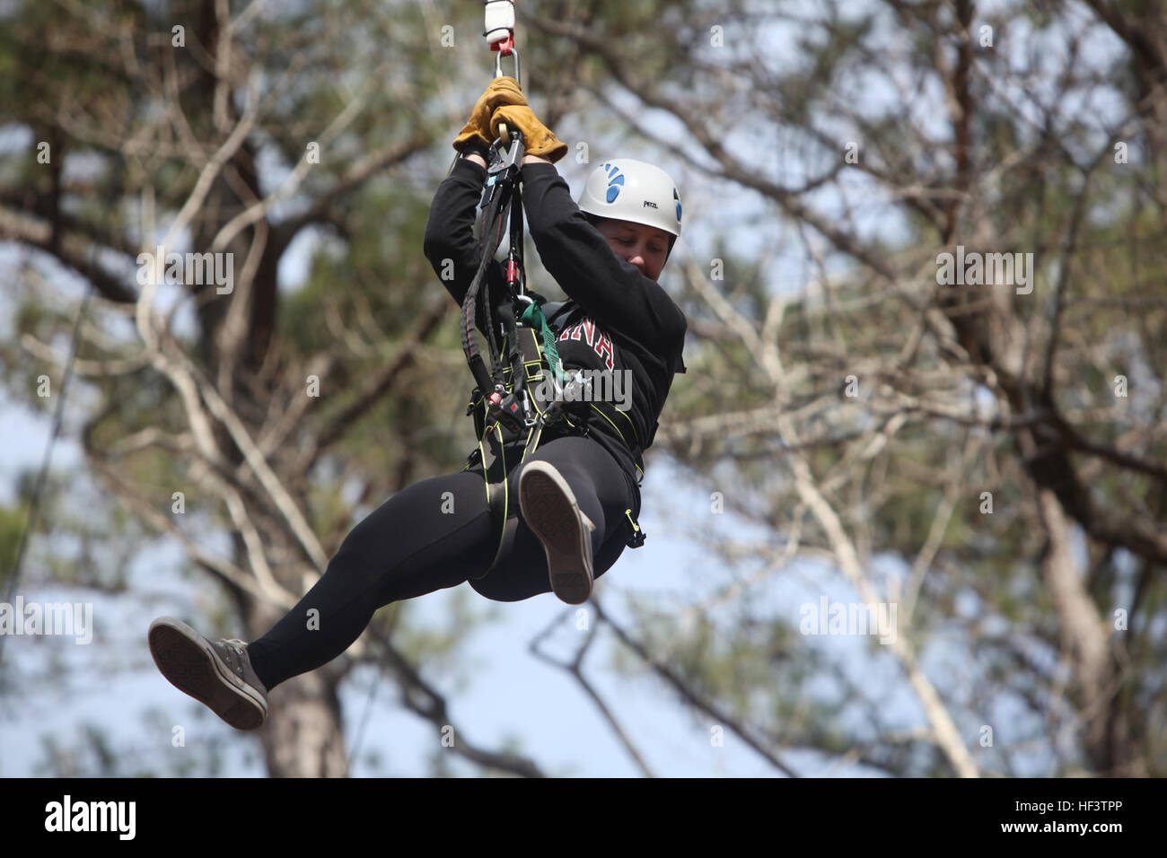 Sgt. Laura B. Freitas descends from a 65-foot free fall tower during the Devil Dog Dare Challenge Course at Marine Corps Air Station Cherry Point, N.C., March 10, 2016. The Devil Dog Dare Challenge Course was designed for Marines and Sailors to get engaged in Operation Adrenaline Rush. OAR is a training tool designed to introduce Marines to activities that serve as alternatives to uncharacteristic behaviors often associated with incidents involving recently deployed Marines. Freitas is a cyber network operator, G-6, 2nd Marine Aircraft Wing. (U.S. Marine Corps photo by Pfc. Nicholas P. Baird/R Stock Photo