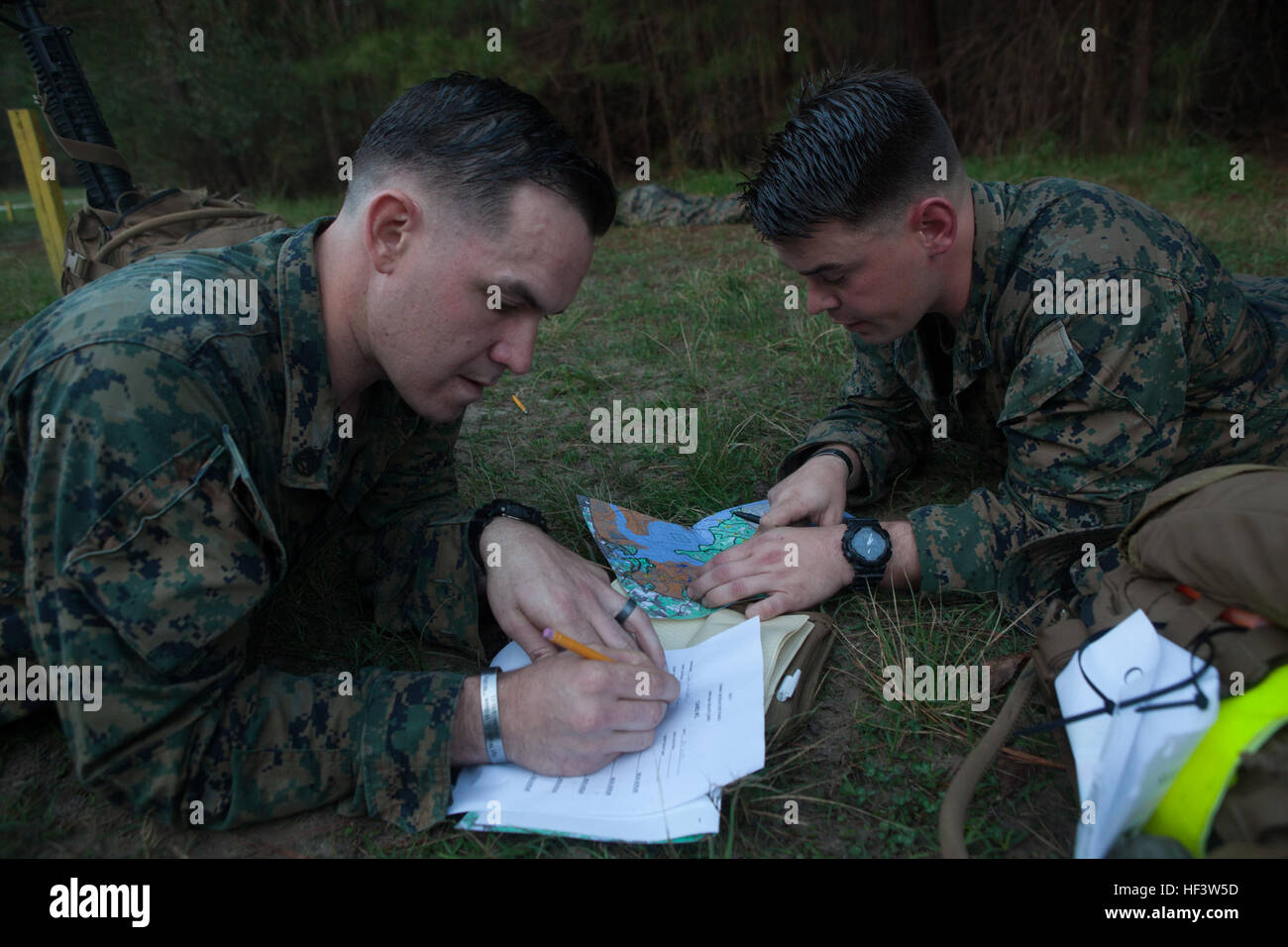 U.S. Marines with the Marine Corps Combat Instructor School, School of Infantry-East, plots a map point during the land navigation portion of the Combat Instructor Stakes Competition on Camp Lejeune, N.C., March 16, 2015. The School of Infantry-East hosted the Combat Instructor Stakes, which is a grueling 30-hour competition that pits two man teams against each other, competing in physical, tactical and knowledge based events while carrying a combat load and moving over 50 kilometers on foot. (U.S. Marine Corps photo by Lance Cpl. Jose Villalobosrocha) Combat Instructor Stakes 160316-M-GY546-0 Stock Photo