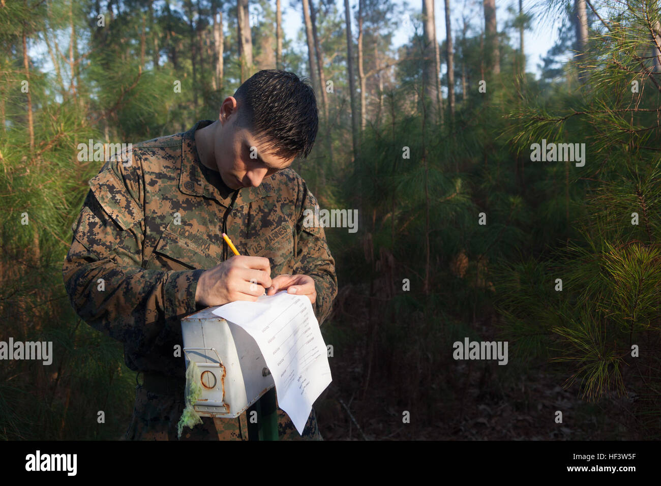 U.S. Marine Staff Sgt. Aldo Gongora, a Combat Instructor with the Marine Corps Combat Instructor School, School of Infantry-East, plots a map point during the land navigation portion of the Combat Instructor Stakes Competition on Camp Lejeune, N.C., March 16, 2015. The School of Infantry-East hosted the Combat Instructor Stakes, which is a grueling 30-hour competition that pits two man teams against each other, competing in physical, tactical and knowledge based events while carrying a combat load and moving over 50 kilometers on foot. (U.S. Marine Corps photo by Lance Cpl. Jose Villalobosroch Stock Photo