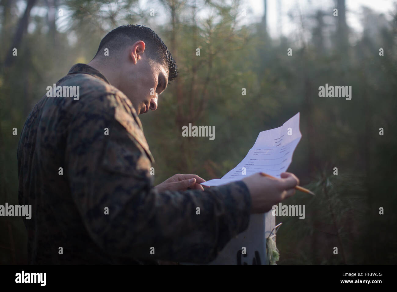 U.S. Marine Staff Sgt. Aldo Gongora, a Combat Instructor with the Marine Corps Combat Instructor School, School of Infantry-East, plots a map point during the land navigation portion of the Combat Instructor Stakes Competition on Camp Lejeune, N.C., March 16, 2015. The School of Infantry-East hosted the Combat Instructor Stakes, which  is a grueling 30-hour competition that pits two man teams against each other, competing in physical, tactical and knowledge based events while carrying a combat load and moving over 50 kilometers on foot. (U.S. Marine Corps photo by SOI-East Combat Camera, Cpl.  Stock Photo
