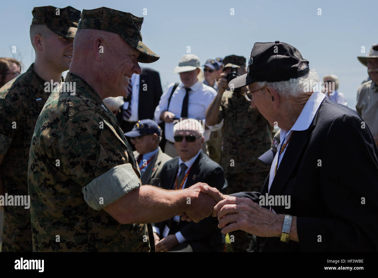 U.S. Marine Corps Lt. Gen. Larry D. Nicholson, left, commanding general, III Marine Expeditionary Force, shakes hands with John Jack Lizere, a U.S. Marine Corps veteran of the Battle of Iwo Jima, during the 71st Commemoration of the Battle of Iwo Jima at Iwo To, Japan, March 19, 2016. The Iwo Jima Reunion of Honor is an opportunity for Japanese and U.S. veterans and their families, dignitaries, leaders and service members from both nations to honor the battle while recognizing 71 years of peace and prosperity in the U.S. – Japanese alliance. (U.S. Marine Corps photo by MCIPAC Combat Camera Lan Stock Photo