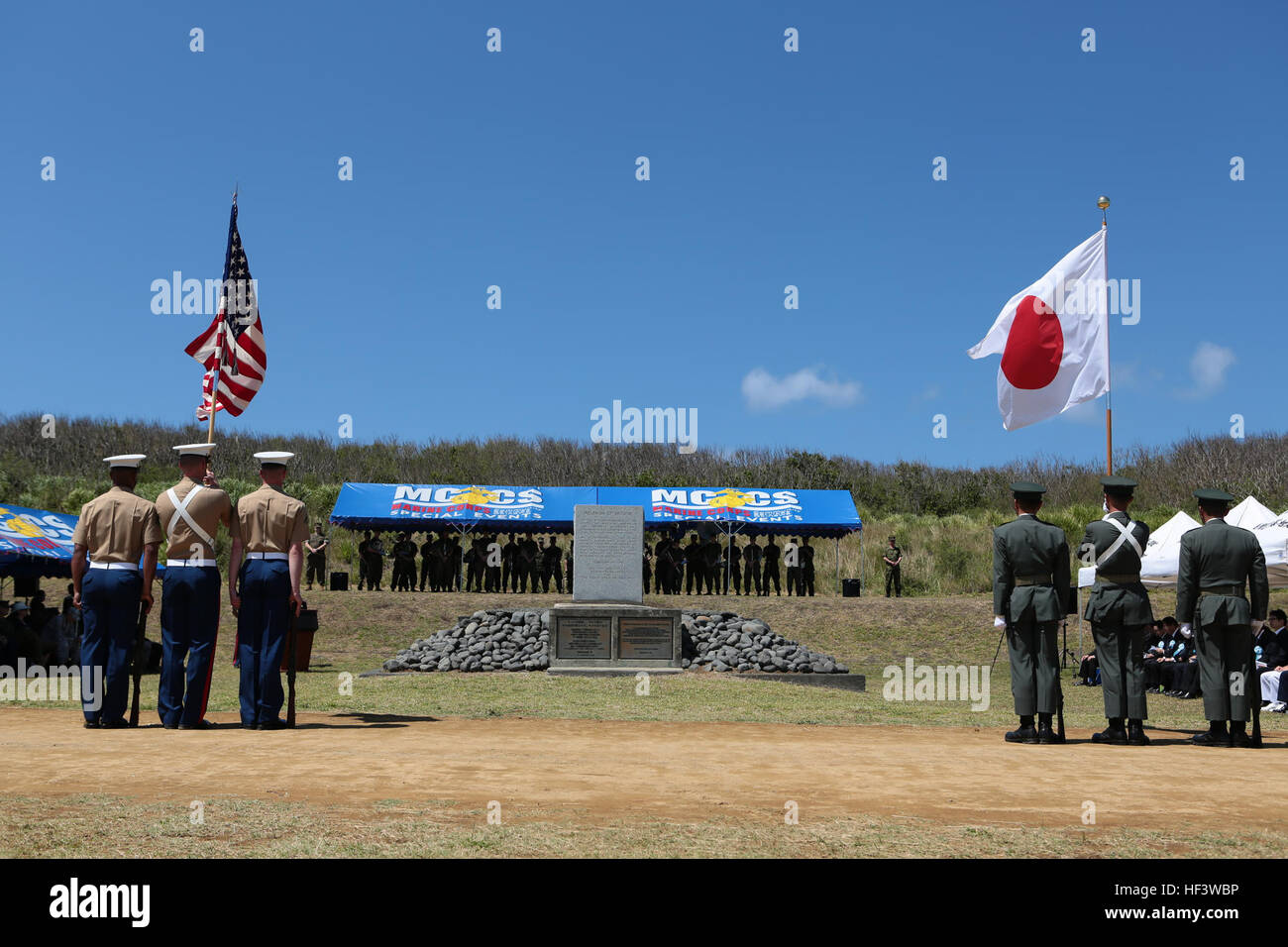 A U.S. Marine Corps and Japanese soldier color guard stands at attention at the commencement of the 71st Commemoration of the Battle of Iwo Jima at Iwo To, Japan, March 19, 2015. The Iwo Jima Reunion of Honor is an opportunity for Japanese and U.S. veterans and their families, dignitaries, leaders and service members from both nations to honor the battle while recognizing 71 years of peace and prosperity in the U.S. – Japanese alliance. (U.S. Marine Corps photo by MCIPAC Combat Camera Lance Cpl. Juan Esqueda / Released) Iwo Jima 71st Reunion of Honor 160319-M-JD520-158 Stock Photo