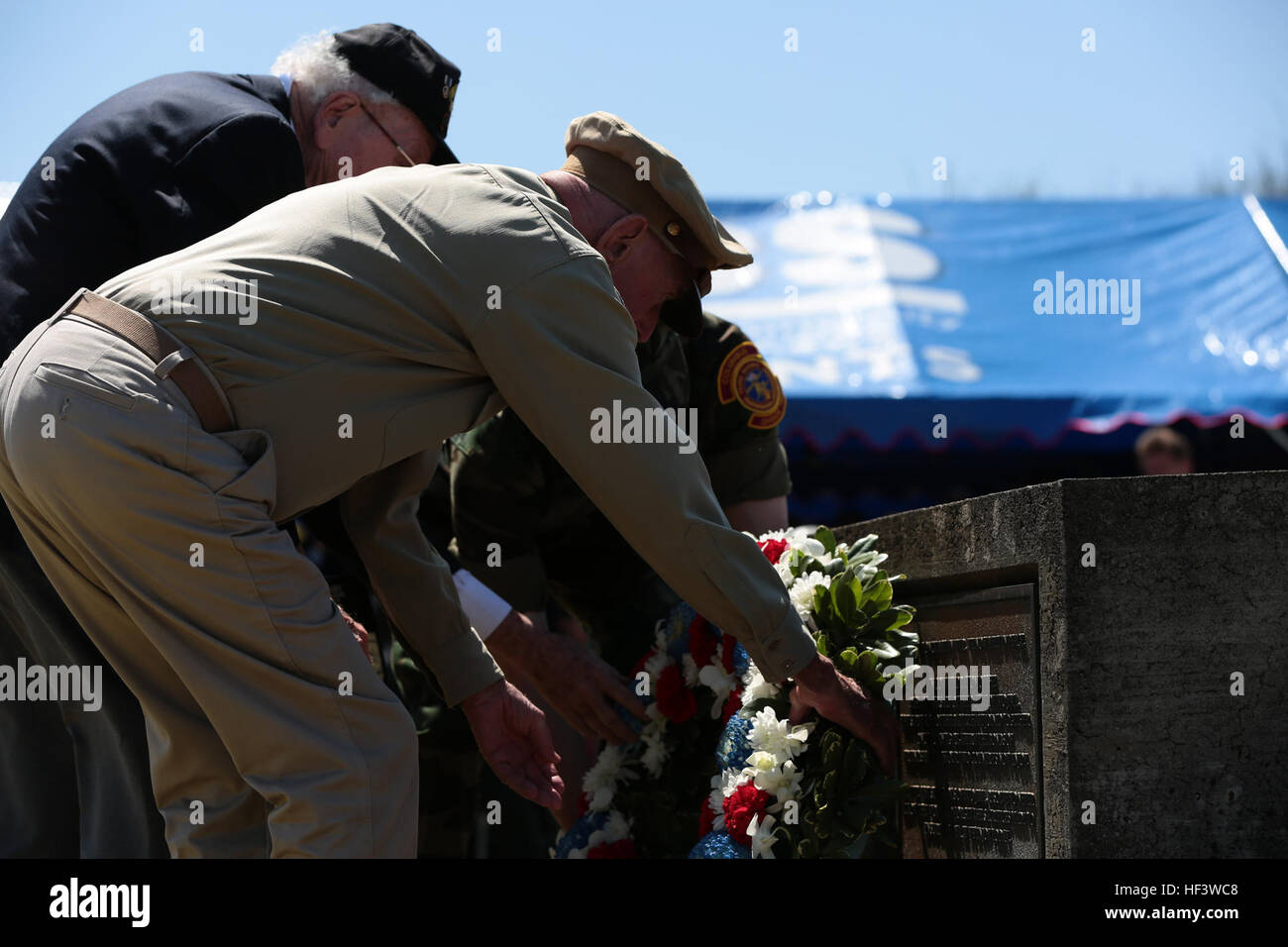 Retired U.S. Army Air Corps Capt. Jerry Yellin , front, and John Jack Lizere, a U.S. Marine Corps veteran of Iwo Jima, present a flower wreath during the 71st Commemoration of the Battle of Iwo Jima at Iwo To, Japan, March 19, 2015. The Iwo Jima Reunion of Honor is an opportunity for Japanese and U.S. veterans and their families, dignitaries, leaders and service members from both nations to honor the battle while recognizing 71 years of peace and prosperity in the U.S. – Japanese alliance. (U.S. Marine Corps photo by MCIPAC Combat Camera Lance Cpl. Juan Esqueda / Released) Iwo Jima 71st Reunio Stock Photo