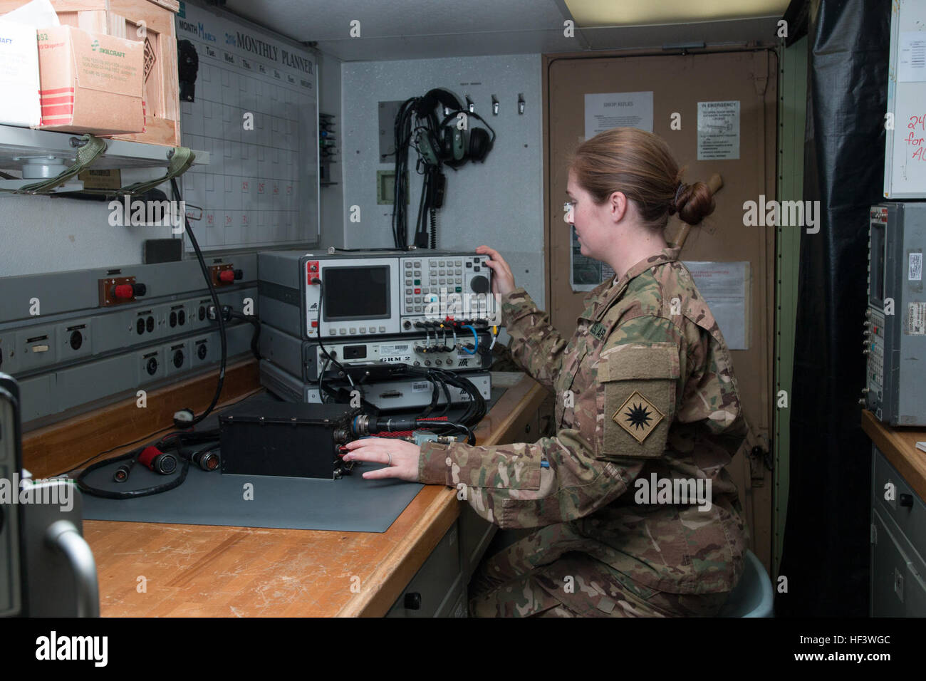 Spc. Selena Landers, a radio communications and security repairer from Dallas, Texas, with Company B, 640th Aviation Support Battalion, 40th Combat Aviation Brigade, operates a radio test set at Camp Buehring, Kuwait, March 23. Landers has a degree in Cultural Anthropology from The University of the South and plans to apply for Officer Candidate School after returning home from deployment. (U.S. Army Photo by Staff Sgt. Ian M. Kummer, 40th Combat Aviation Brigade Public Affairs) Woman warriors deploy with the 40th CAB 160323-Z-JK353-008 Stock Photo