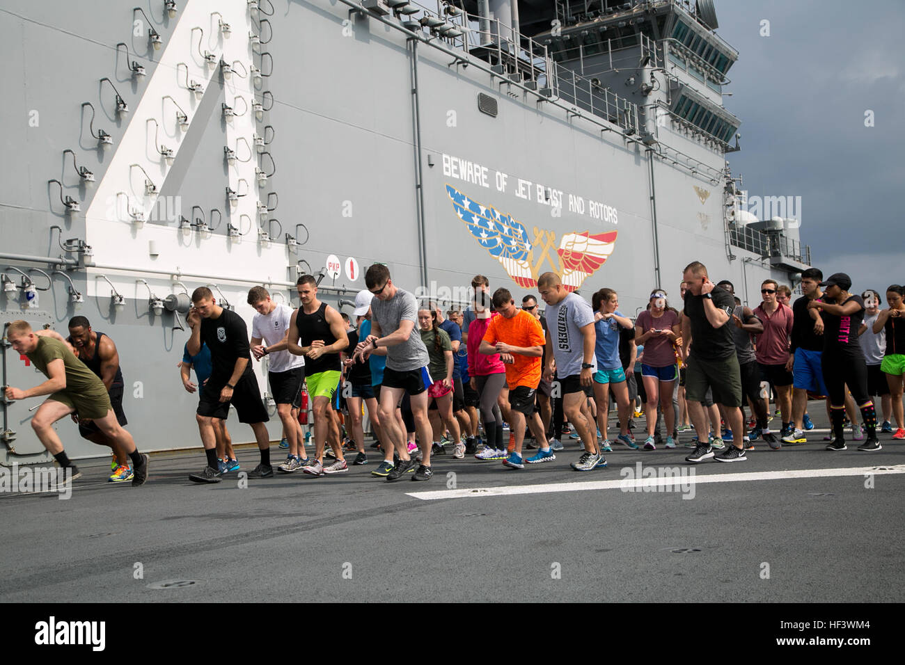 At sea. (March 27, 2016)-U.S. Marines and Sailors with the 13th Marine Expeditionary Unit and Boxer Amphibious Ready Group, take off at the starting line of a 5k run for women's history month, March 27, 2016, during the MEU's western pacific deployment aboard the USS Boxer. More then 4,500 Marines and Sailors from the Boxer ARG, 13th MEU team are currently transiting the Pacific Ocean toward the U.S. 5th fleet area of operations during a scheduled deployment. (U.S. Marine Corps photo by Sgt. Briauna Birl/RELEASED) Women's History 5k aboard USS Boxer 160327-M-KR317-044 Stock Photo