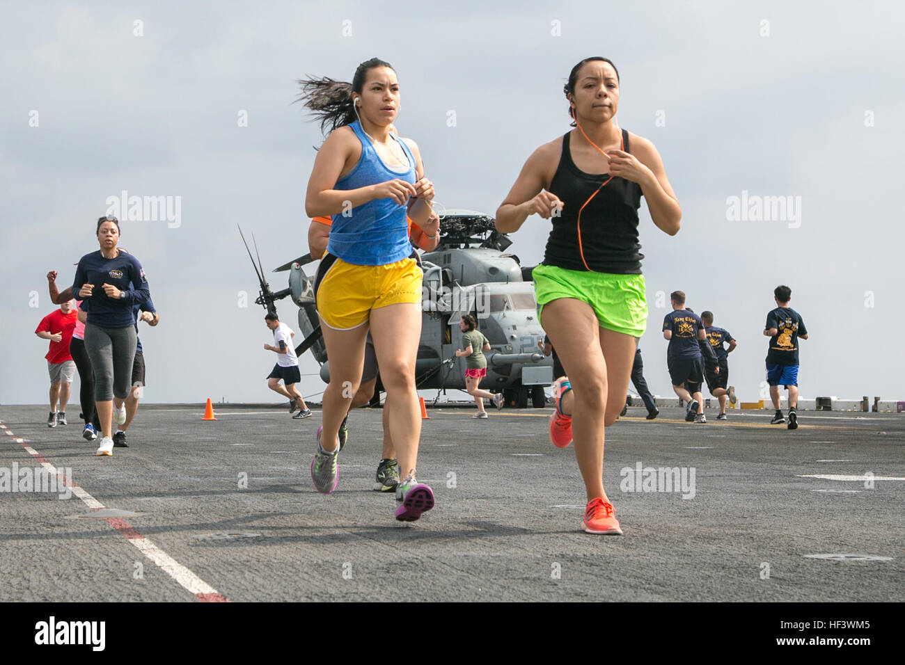At sea. (March 27, 2016)-U.S. Marines Sgt. Priscilla Castillo and Sgt Liliana Sandoval, 13th Marine Expeditionary Unit listen to music as they participate in a 5k run for women's history month, March 27, 2016, during the MEU's western pacific deployment aboard the USS Boxer. More then 4,500 Marines and Sailors from the Boxer ARG, 13th MEU team are currently transiting the Pacific Ocean toward the U.S. 5th fleet area of operations during a scheduled deployment. (U.S. Marine Corps photo by Sgt. Briauna Birl/RELEASED) Women's History 5k aboard USS Boxer 160327-M-KR317-070 Stock Photo