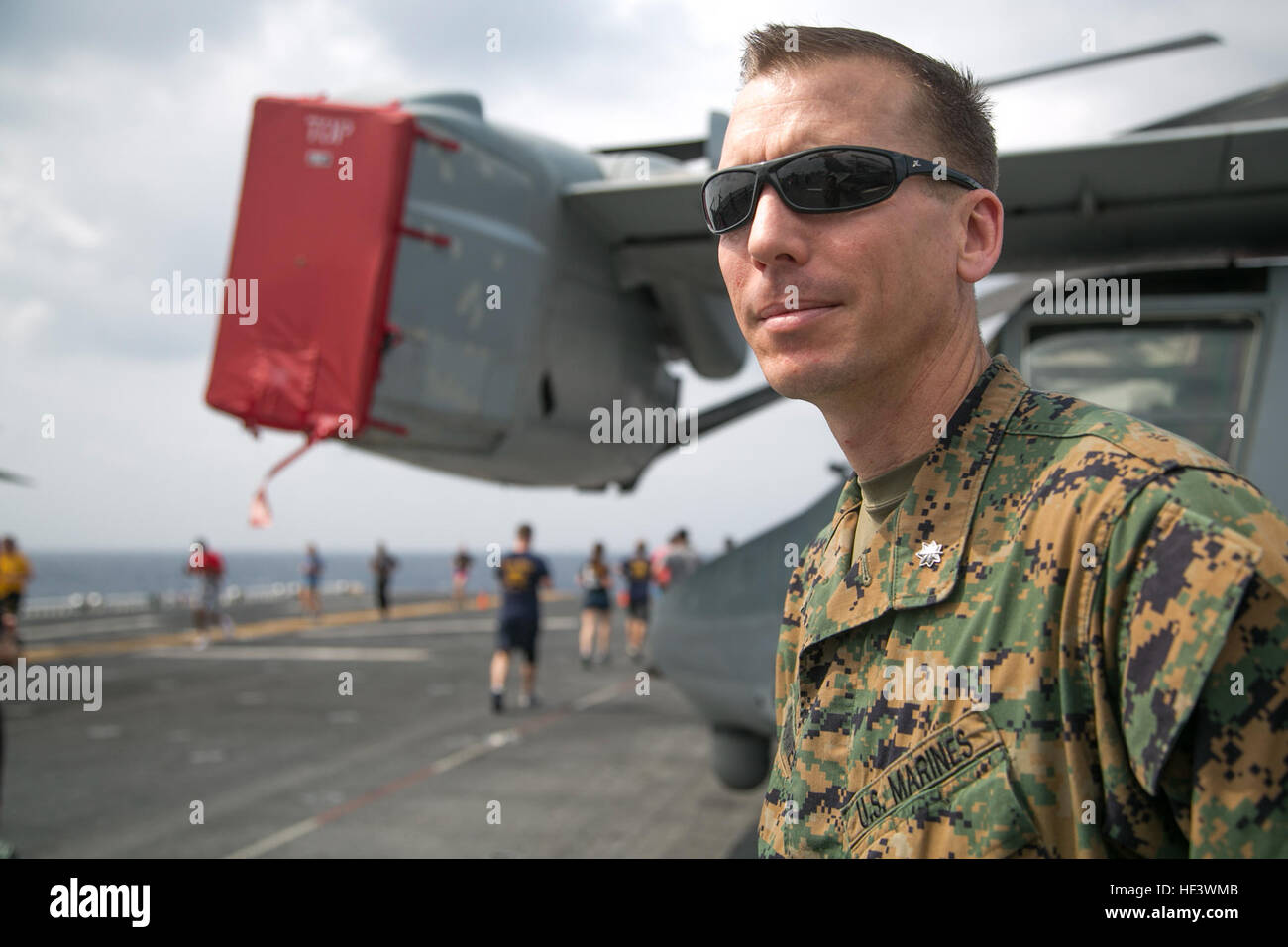 At sea. (March 27, 2016)-U.S. Marine Lt. Col. Terence Connelly, Commanding Officer, Combat Logistics Battalion 13, 13th Marine Expeditionary Unit; cheers on participants in a 5k run for women's history month, March 27, 2016, during the MEU's western pacific deployment aboard the USS Boxer. More then 4,500 Marines and Sailors from the Boxer ARG, 13th MEU team are currently transiting the Pacific Ocean toward the U.S. 5th fleet area of operations during a scheduled deployment. (U.S. Marine Corps photo by Sgt. Briauna Birl/RELEASED) Women's History 5k aboard USS Boxer 160327-M-KR317-195 Stock Photo