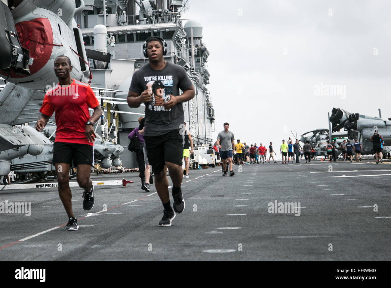 At sea. (March 27, 2016)-U.S. Sailor Capt. Keith Moore, Commodore of Boxer Amphibious Ready Group, runs with Cpl. James Rodgers, 13th Marine Expeditionary Unit, in a 5k run for women's history month, March 27, 2016, during the MEU's western pacific deployment aboard the USS Boxer. More then 4,500 Marines and Sailors from the Boxer ARG, 13th MEU team are currently transiting the Pacific Ocean toward the U.S. 5th fleet area of operations during a scheduled deployment. (U.S. Marine Corps photo by Sgt. Briauna Birl/RELEASED) Women's History 5k aboard USS Boxer 160327-M-KR317-218 Stock Photo
