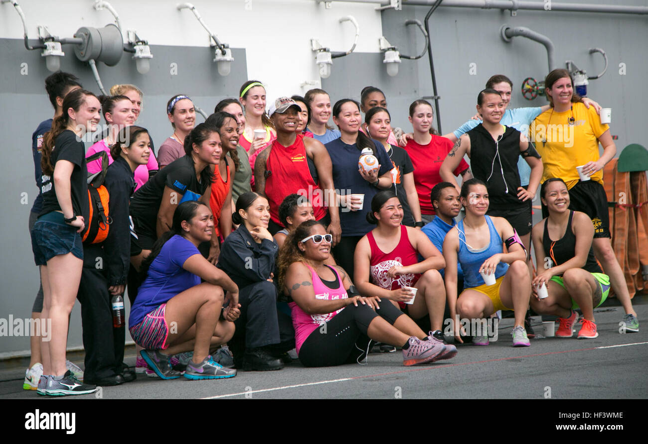 At sea. (March 27, 2016)-Female U.S. Marines and Sailors with the 13th Marine Expeditionary Unit and Boxer Amphibious Ready Group, gather for a group photo after participating in a 5k run for women's history month, March 27, 2016, during the MEU's western pacific deployment aboard the USS Boxer. More then 4,500 Marines and Sailors from the Boxer ARG, 13th MEU team are currently transiting the Pacific Ocean toward the U.S. 5th fleet area of operations during a scheduled deployment. (U.S. Marine Corps photo by Sgt. Briauna Birl/RELEASED) Women's History 5k aboard USS Boxer 160327-M-KR317-240 Stock Photo