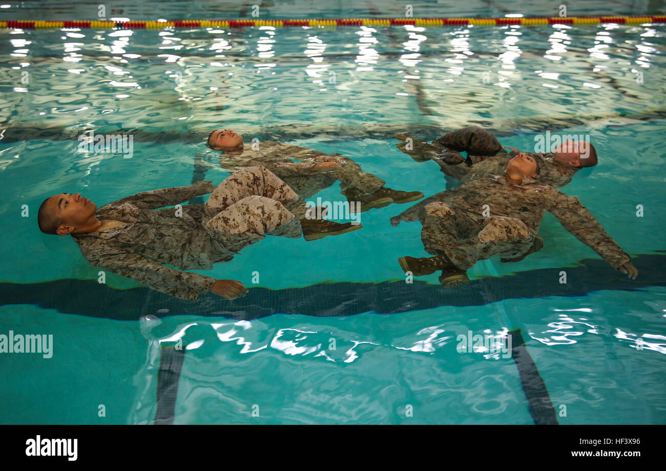 Recruits of Lima Company, 3rd Recruit Training Battalion, perform the four-minute water tread during the Water Survival Basic Qualification at Marine Corps Recruit Depot San Diego, April 11. Fear and lack of confidence caused some to become stressed and panicked, which made them forget the techniques they were taught. Annually, more than 17,000 males recruited from the Western Recruiting Region are trained at MCRD San Diego. Lima Company is scheduled to graduate June 10. Co. L - Swim Qualification 160411-M-WQ808-006 Stock Photo