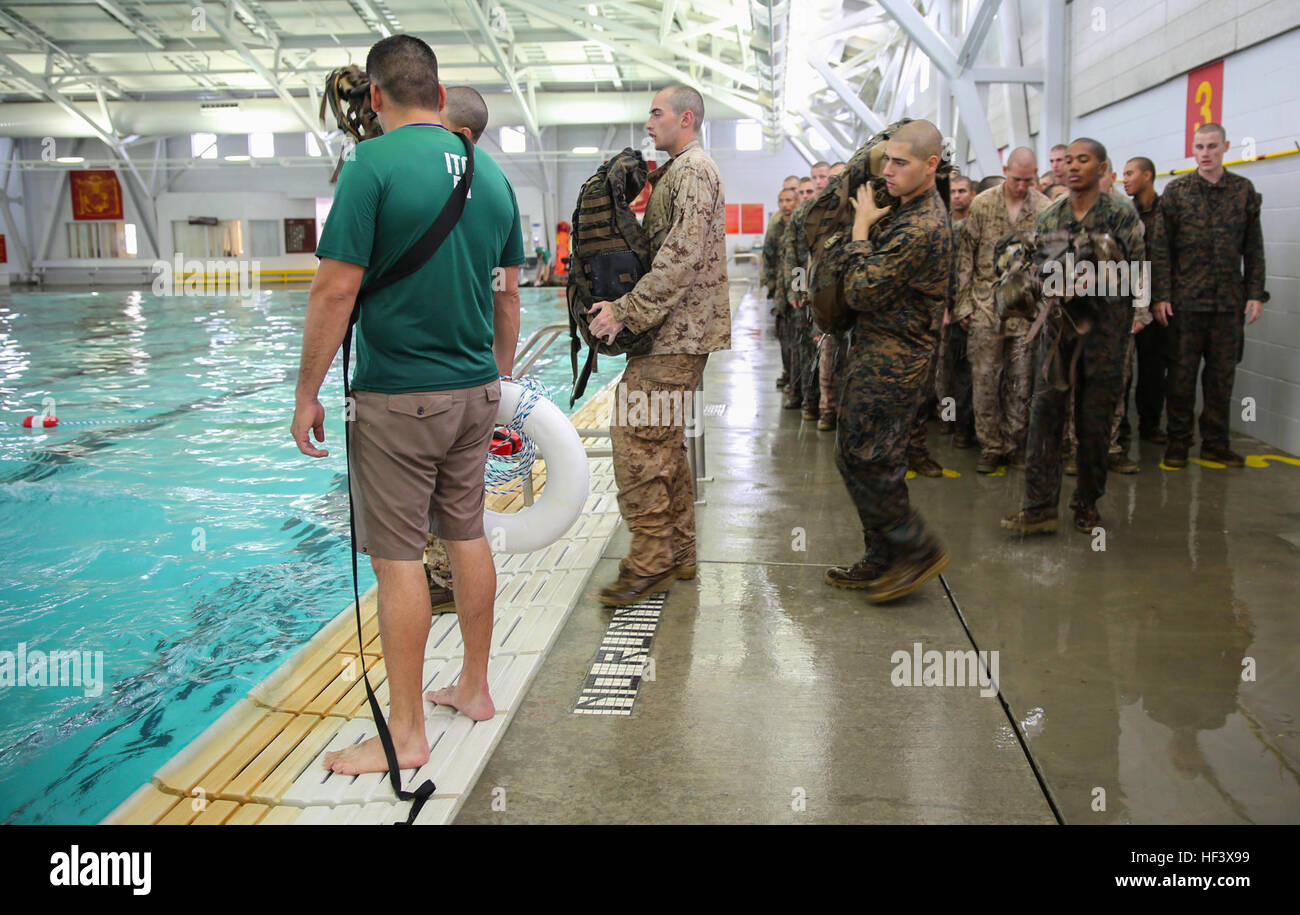 Recruits of Lima Company, 3rd Recruit Training Battalion, prepare to perform a 25-meter swim using a waterproof pack during the Water Survival Basic Qualification at Marine Corps Recruit Depot San Diego, April 11. The swim qualification introduces new challenges that recruits must overcome in order to graduate recruit training. Annually, more than 17,000 males recruited from the Western Recruiting Region are trained at MCRD San Diego. Lima Company is scheduled to graduate June 10. Co. L - Swim Qualification 160411-M-WQ808-045 Stock Photo